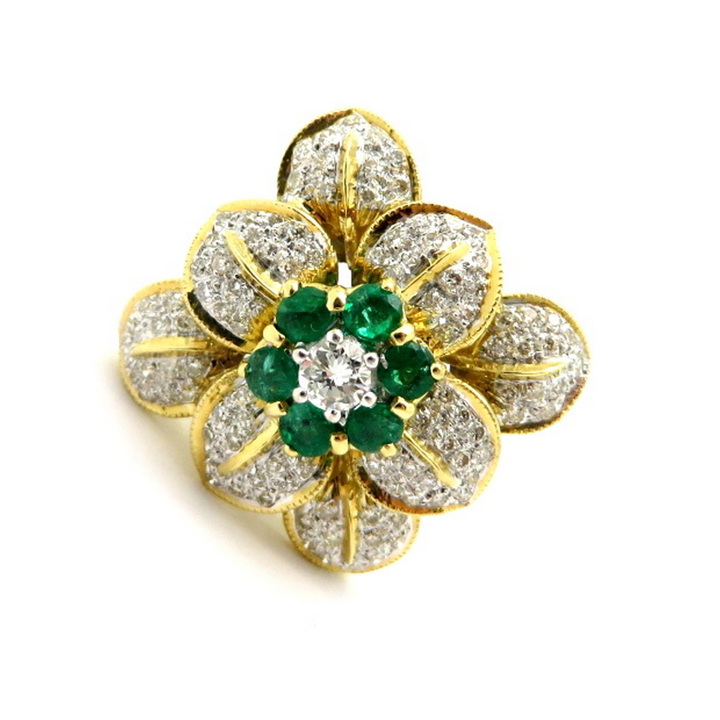 Estate 18K yellow gold flower emerald and diamond fashion ring. Showcasing 104 pave set round brilliant cut diamonds weighing a combined total of approximately 0.77 carats. Diamond grading: color grade: G – H. Clarity grade: VS1 – VS2. It is a