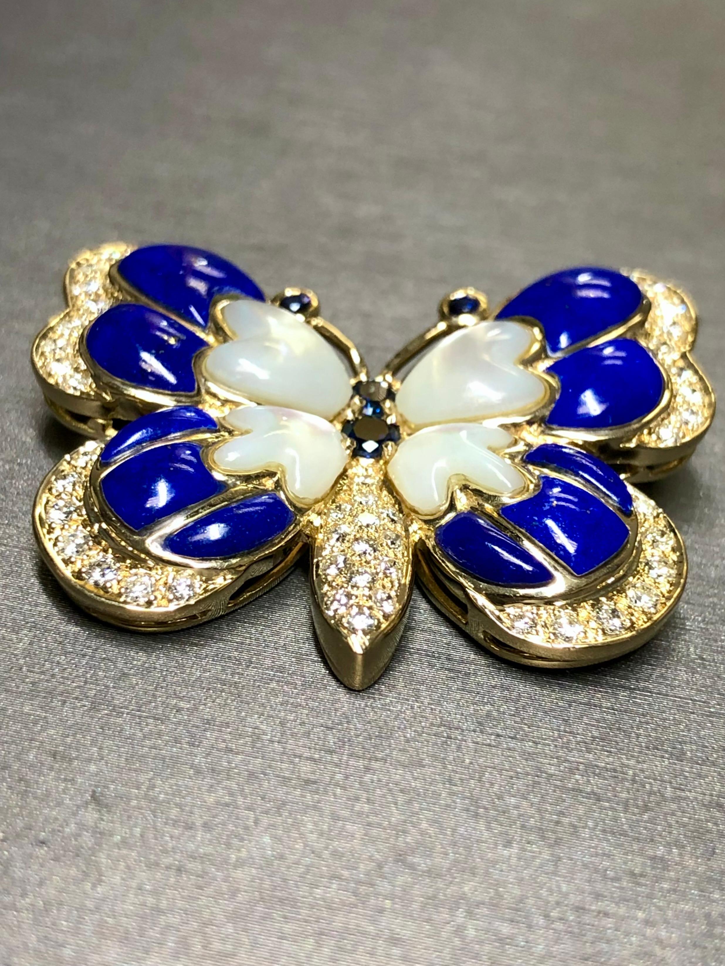 A hand crafted pin done in 18K yellow gold inlaid with lapis and mother of pearl and set with .75cttw in G-I color Vs2-SI1 Camry diamonds as well as .38cttw in natural sapphires.


Dimensions/Weight:

Brooch measures 1.45” by 1.25” and weighs