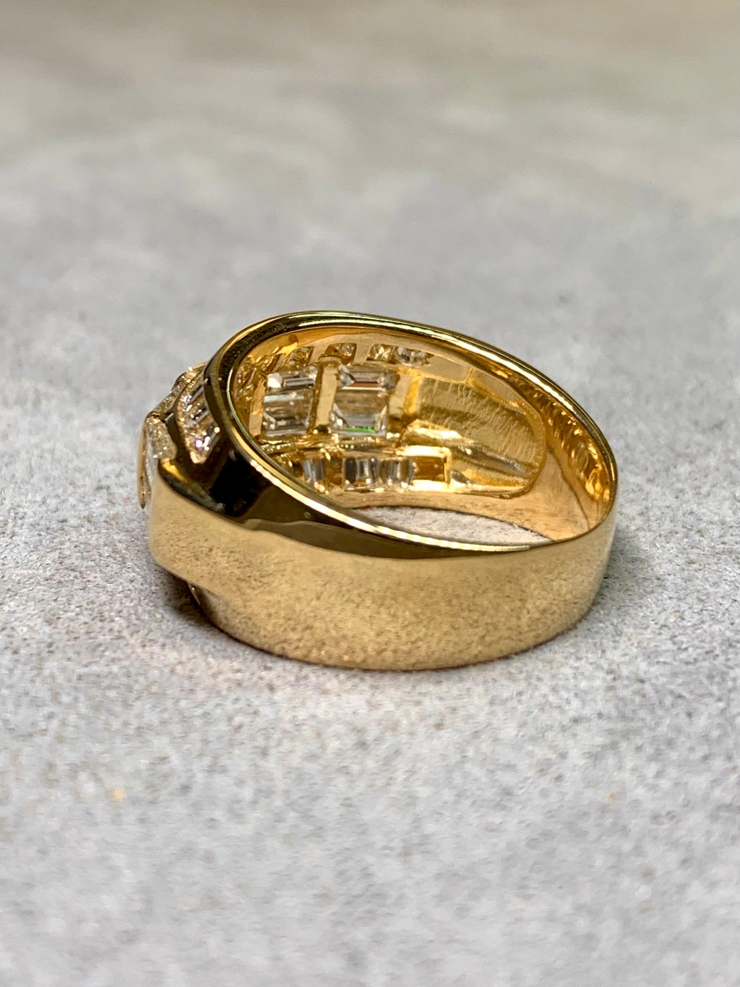 
A bold and beautifully made diamond band ring crafted in 18K yellow gold. This substantial piece is set with approximately 3.44 carats total weight of baguette-cut diamonds, the largest stones averaging about 0.20 carats each. The diamonds are
