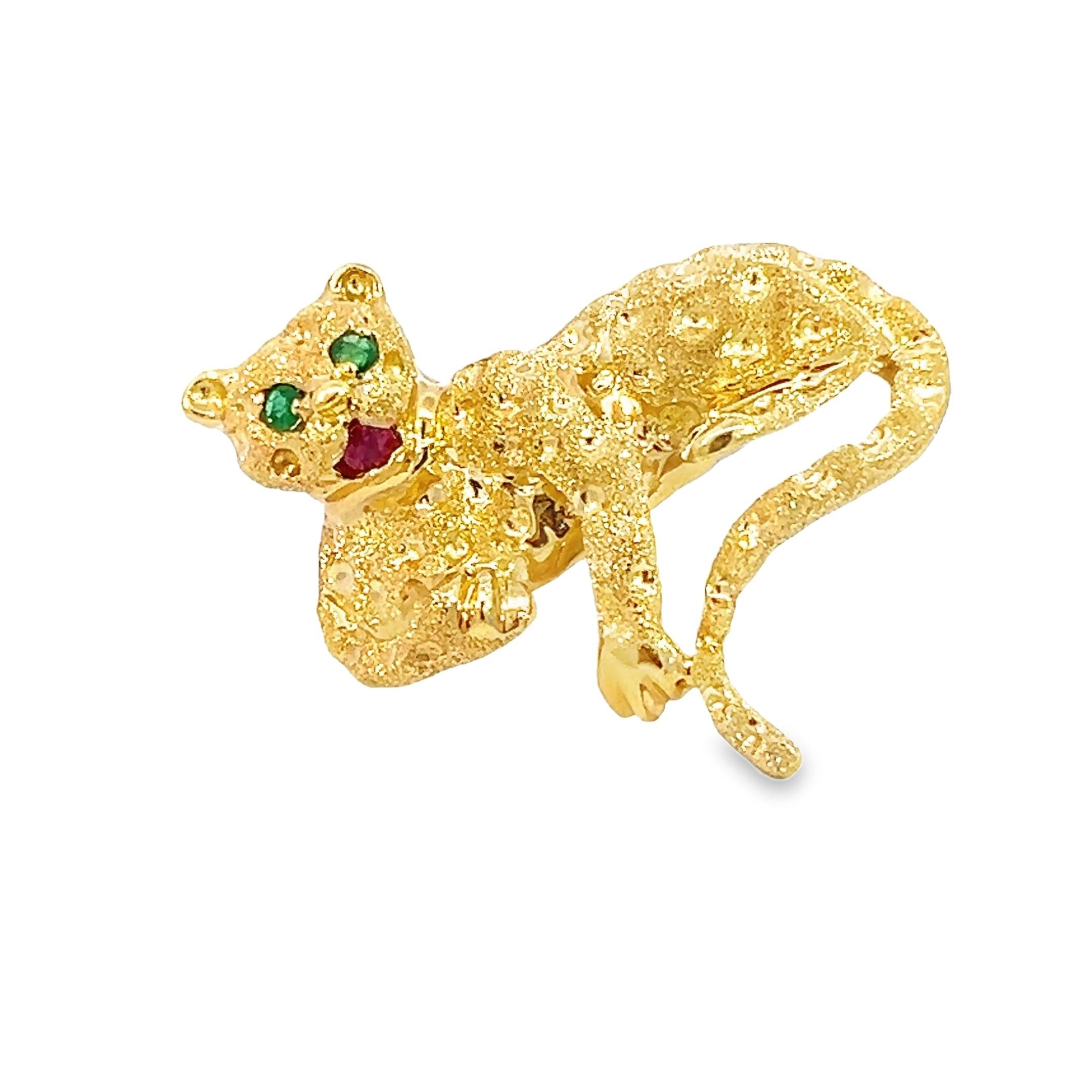 Estate 18K yellow gold panther brooch pin embodies elegance and wild beauty, featuring vivid green emerald eyes and a striking royal red ruby mouth. A true statement piece, this finely crafted brooch weighs 15.3 grams and is stamped 18K and LM,