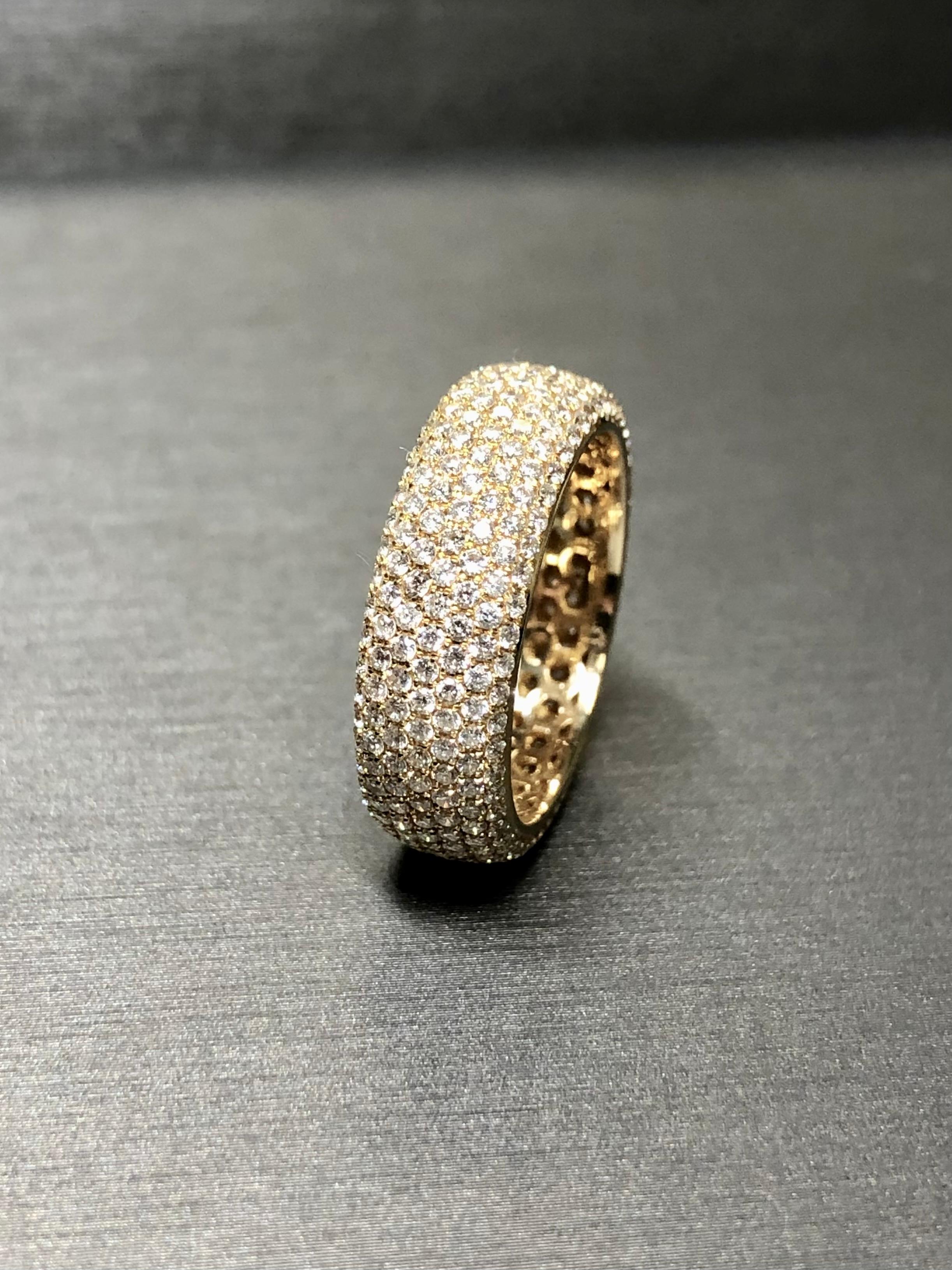 An extremely well made paved band that won’t catch on clothing even if you try! Crafted in 18K yellow gold, this band has been incredible well set with approximately 3.50cttw in G-I color Vs2 to Si1 clarity round diamonds. Beautifully executed and