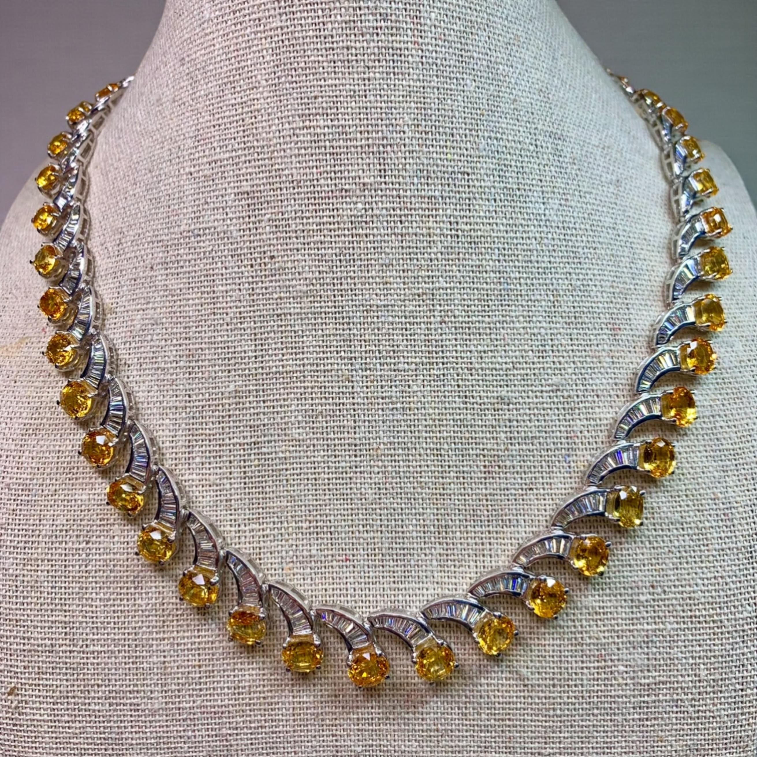 A showstopper of a necklace! Done in 18K white gold, this necklace has been channel set with approximately 11cttw in G-I color Vs2-Si1 clarity baguette diamonds as well as approximately 40cttw in yellow sapphires.

Dimensions/Weight
Measures 17”