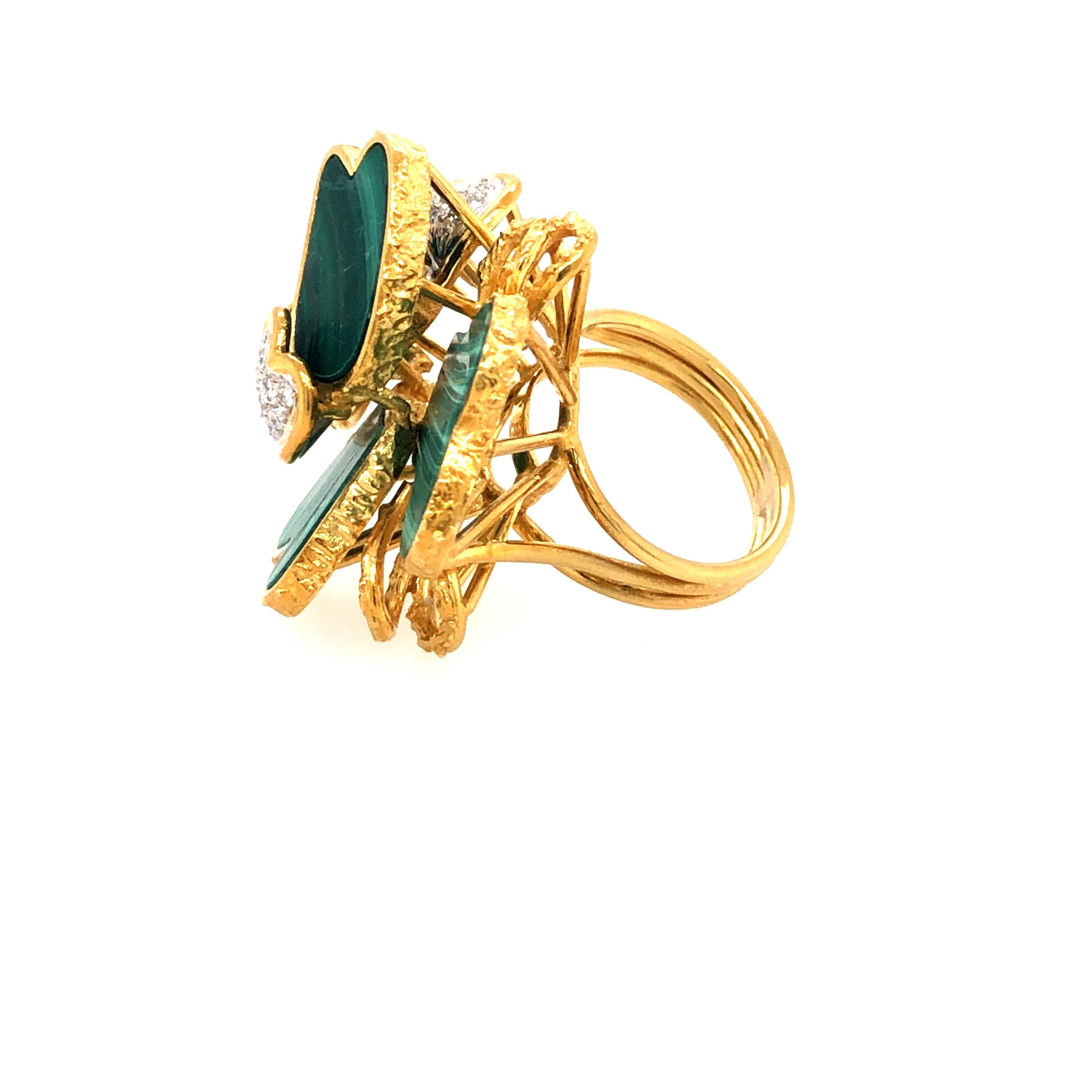 Offered here is a contemporary high end brand name ring, made in solid 18kt yellow and white gold weighing 17 grams.
Ring features 4 natural malachite and leafs are adorned with a total of 17 natural earth mined to quality diamonds weighing