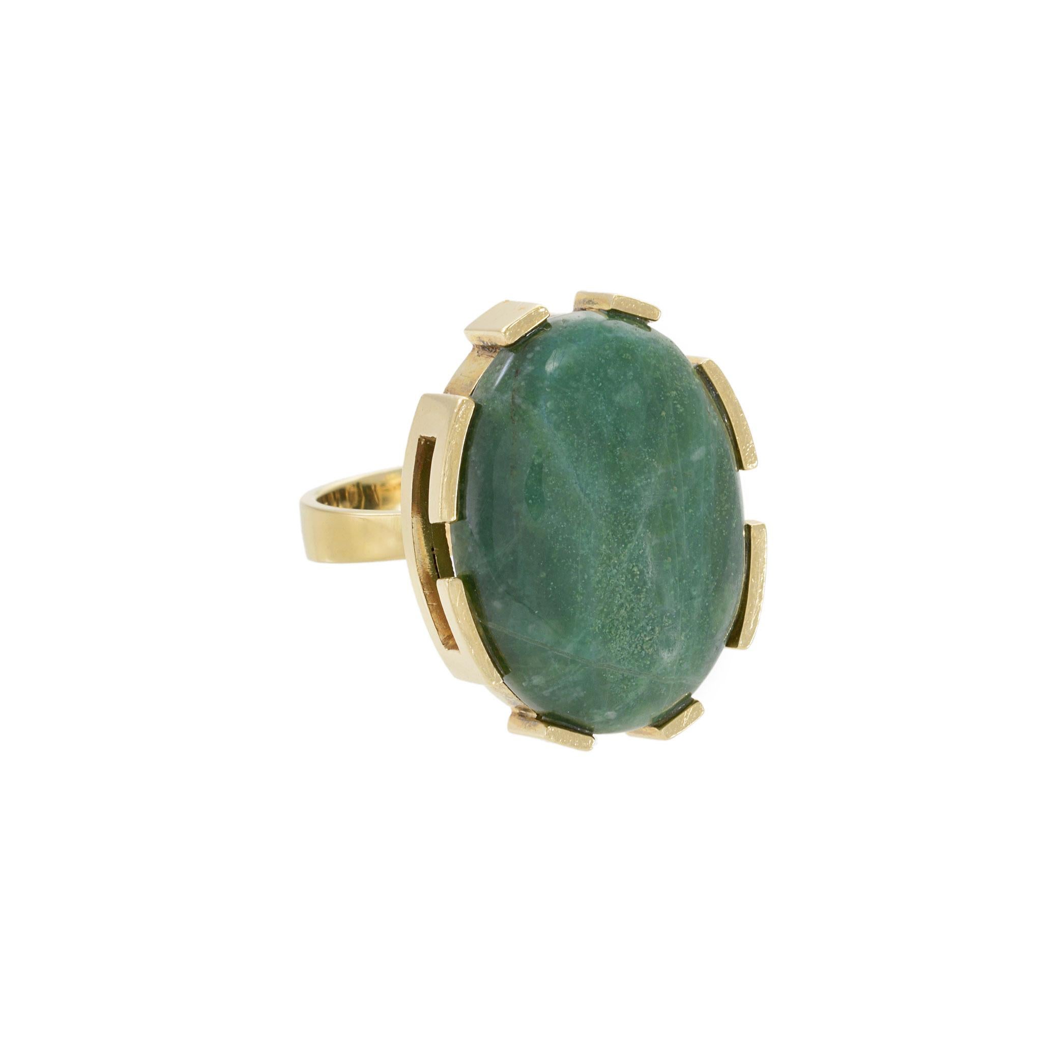 This stunning 18KT yellow gold ring is a vintage beauty from the 1970s. The oval green jade stone gives off an elegant and classic aura, making it a timeless piece to add to any collection. The high-quality craftsmanship and rare gemstone make this