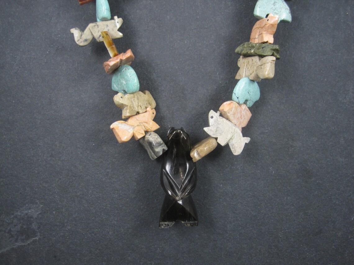 This gorgeous vintage fetish necklace is from the 70s.
It features 47 carved gemstone animals.

Measurements: 32 inches from end to end
To give you an idea of size, the large focal bear is just shy of 2 inches tall.
Weight: 156.2 grams