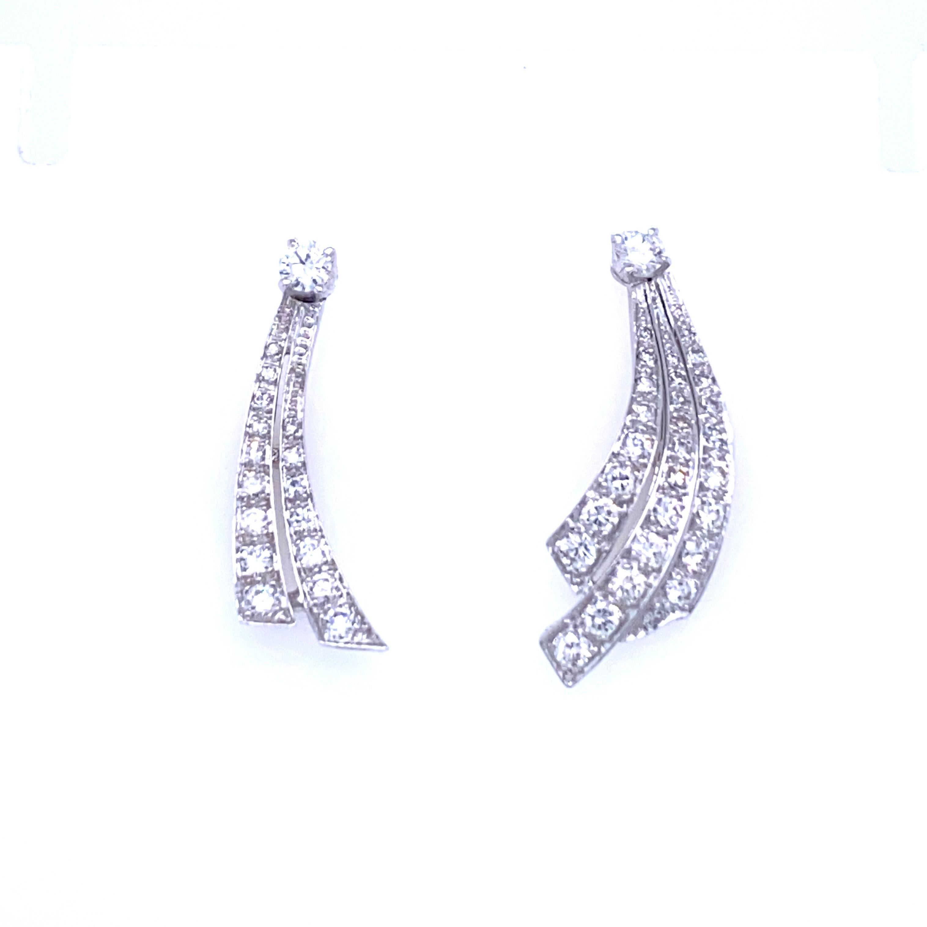 These Estate with a very contemporary taste diamond platinum earrings feature sparkling Round brilliant cut diamonds weighing approximately 2.20 carat. graded F-G color with VvS clarity. 
Circa 1960, Italy

Please note, each earring is different