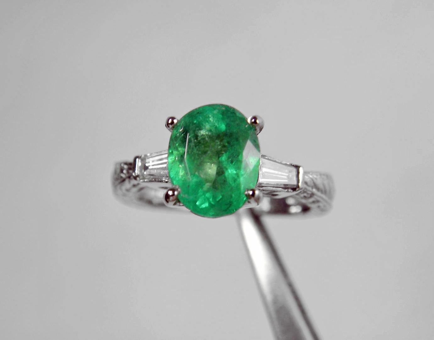 Primary Stone: Natural Colombian Emerald
Shape or Cut: Oval Cut 
Emerald Weight: 1.89 Carats (1 emerald)
Measurements Emerald: 8.92mmx7.12mm
Average Color: Natural Medium Green 
Average Clarity: VS 
Accent Stones: Genuine Diamond
Shape or Cut
