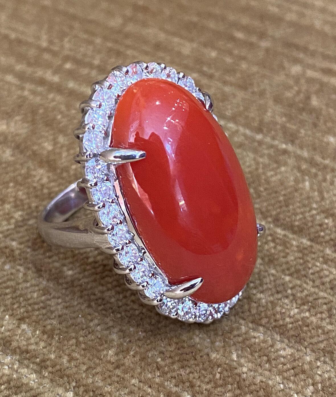 Estate 22.95 carats Red Coral & Diamond Cocktail Ring in Platinum

Estate Red Coral and Diamond Cocktail Ring features a 22.95 carat Oval-shaped Red Coral in the center surrounded by a halo of 30 Round Brilliant cut Diamonds, all set in