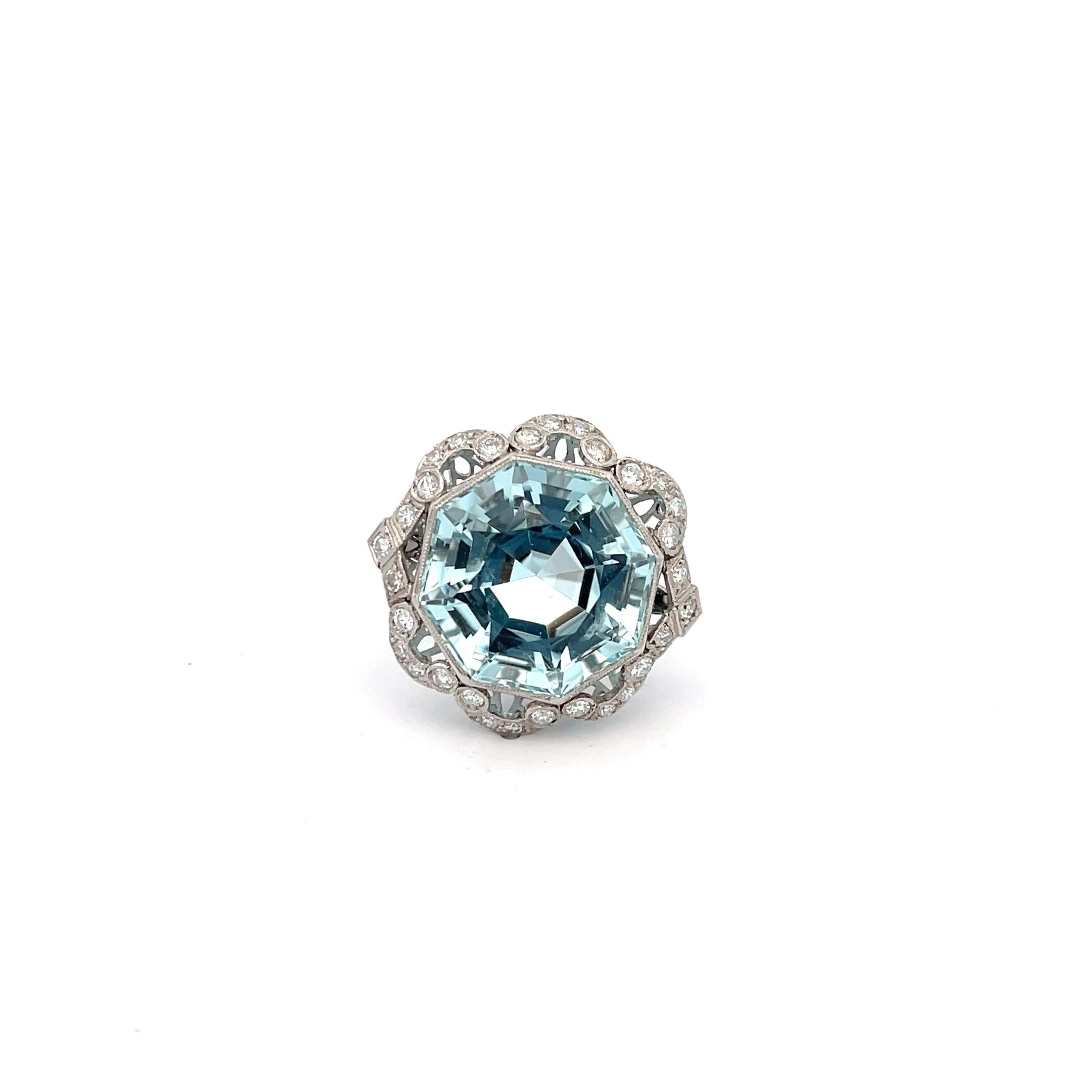 Estate Aquamarine and Diamond Ring in Platinum. The ring features a 22ct hexagon cut aquamarine accented by approximately 1ctw of diamonds. The ring is size 8 and weighs 11 grams.