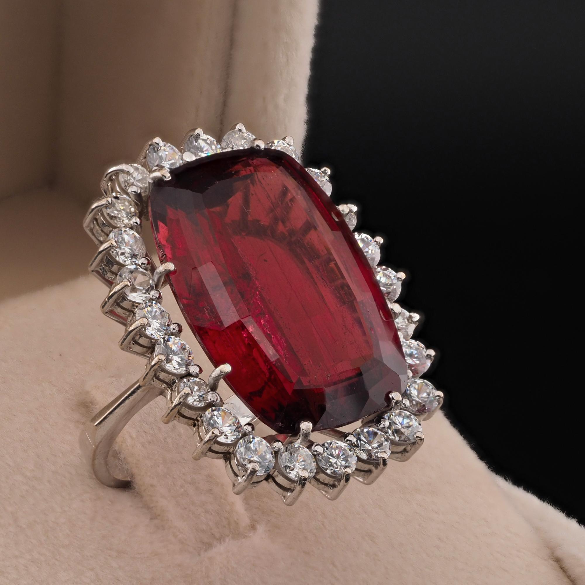 25.00 Carats Earth Gift
Extraordinary estate ring set with a natural untreated Red Rubellite, totally natural, earth gift – 25.00 Ct. prizing stunning Red Colour
Hand crafted mount of solid 18 Kt white gold, marked
Centre red Rubellite is 25.00 Ct