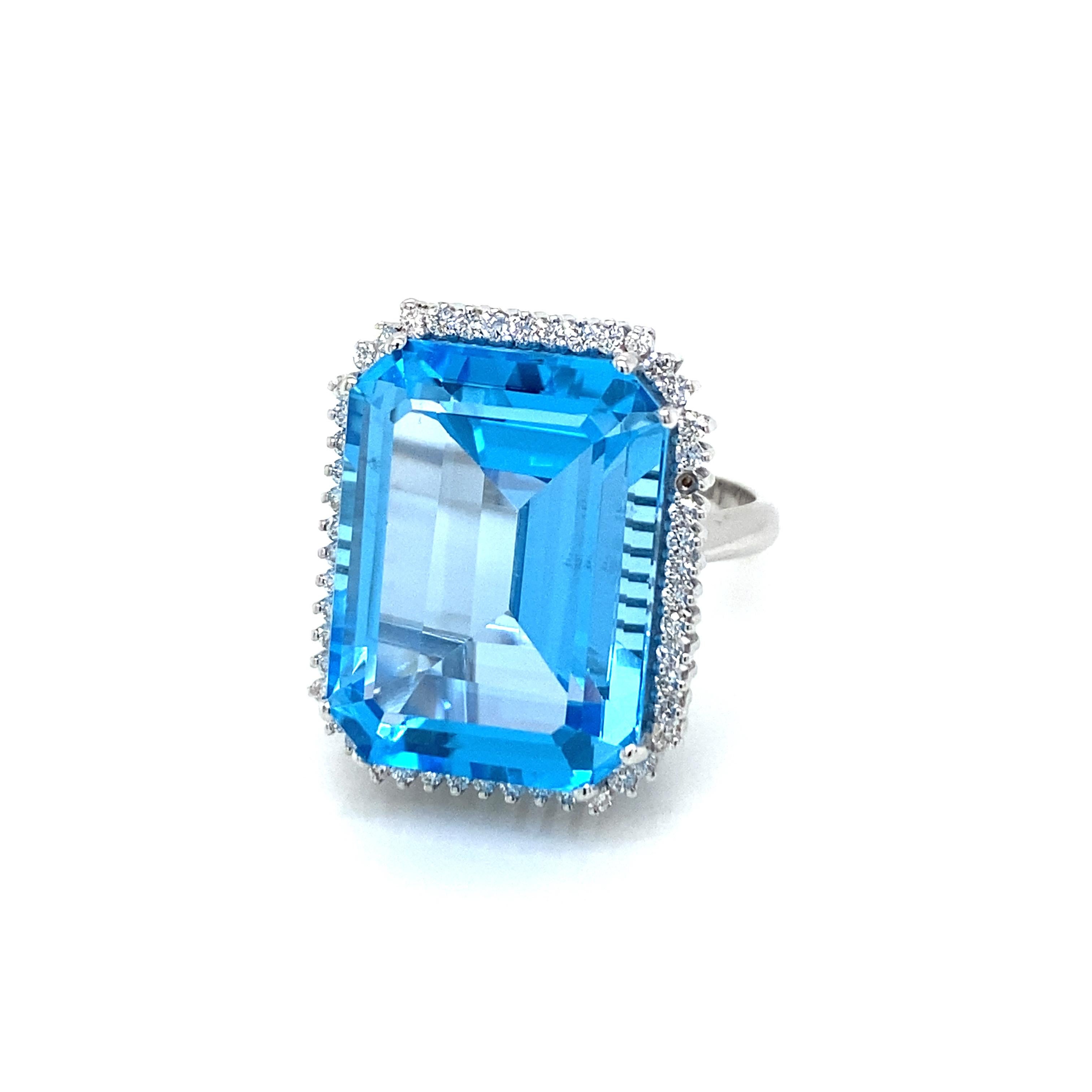 Beautiful and unusual Ring hand crafted in 18k white gold set with a large Natural sparkling Large Topaz of 28,35 carat, it features an amazing vivid color with excellent clarity, and surrounded by approx. 0,50 carat of Colorless round brilliant cut