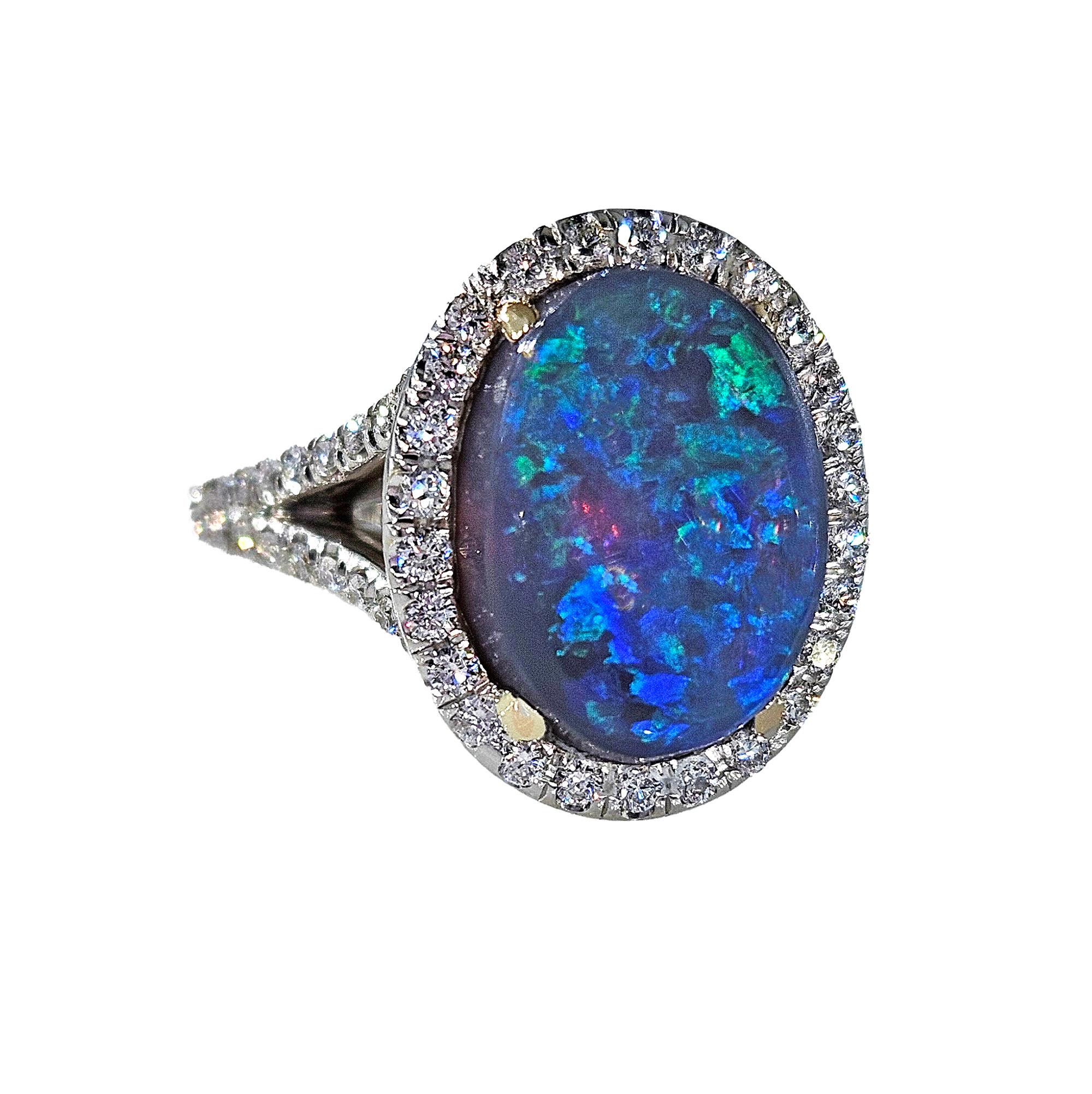STUNNING RICH MULTI COLOR, FIREY Australian Black Opal Ring from the Lighting Ridge Mine & White Diamonds 18k White Yellow Gold Ring.
Highly prized and sought after by kings, emperors, maharajas and sultans, the majestic Opal has been desired