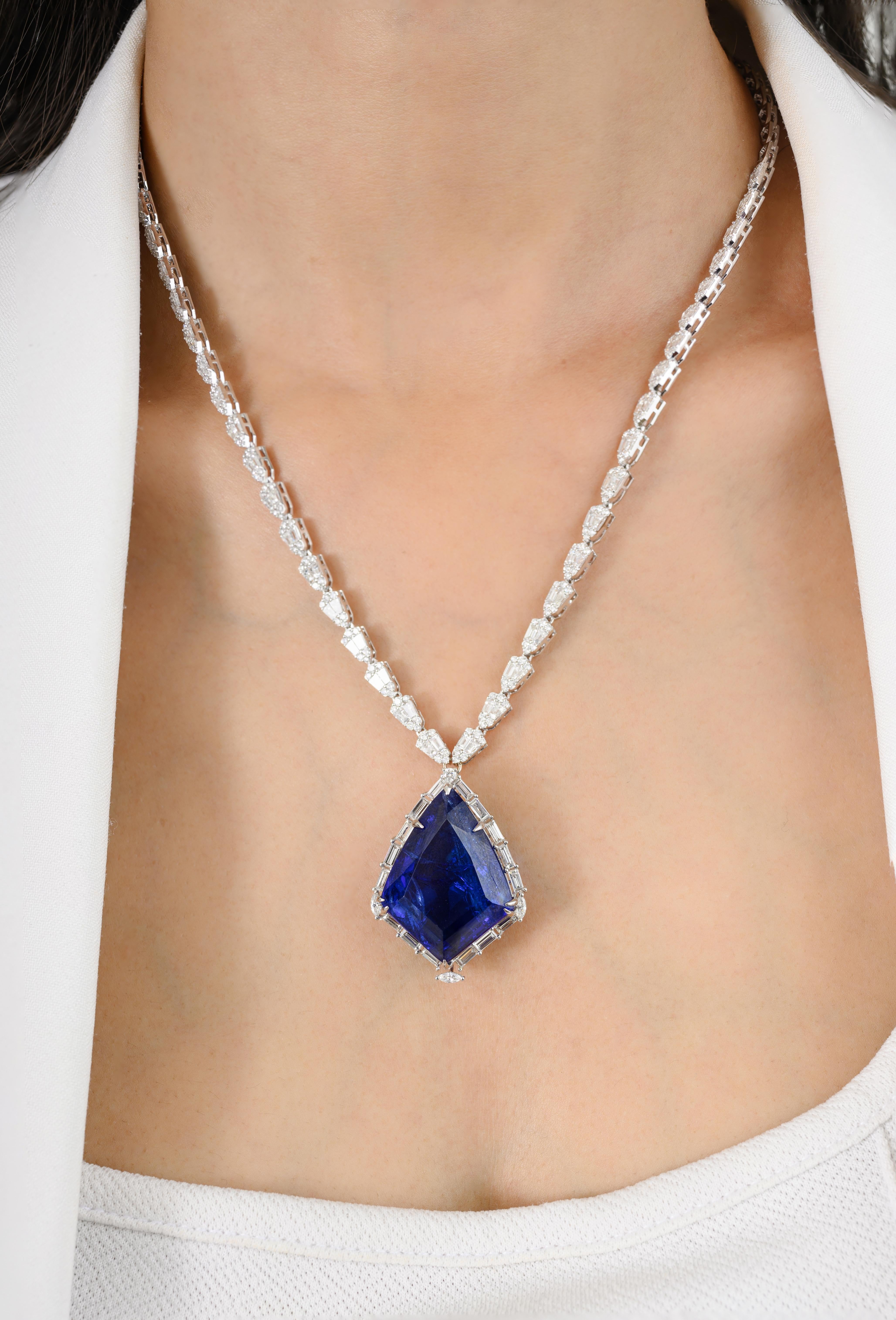 Estate 35.94 CTW Tanzanite 5.56 CTW Diamond Necklace in 18K Gold with diamond studded around kite shape tanzanite. This stunning piece of jewelry instantly elevates a casual look or dressy outfit. 
Tanzanite brings energy, calmness and happiness