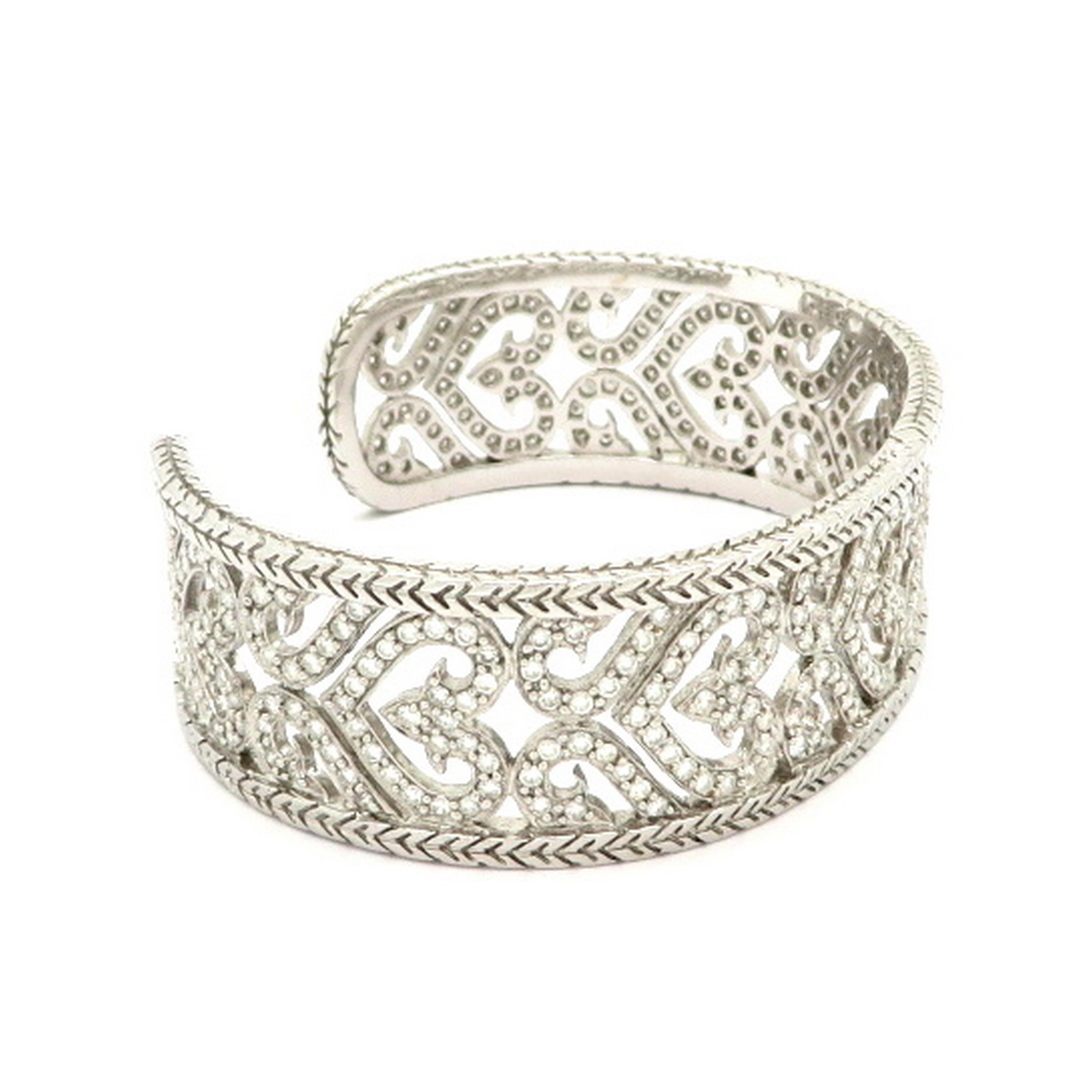 Estate 3.64 carat designer Chad Allison heart motif diamond cuff bangle bracelet. The bracelet is crafted out of 18K white gold. The inner dimensions are 53 x 43 mm. The bracelet has a heart motif with a leaf style engraved border. It features