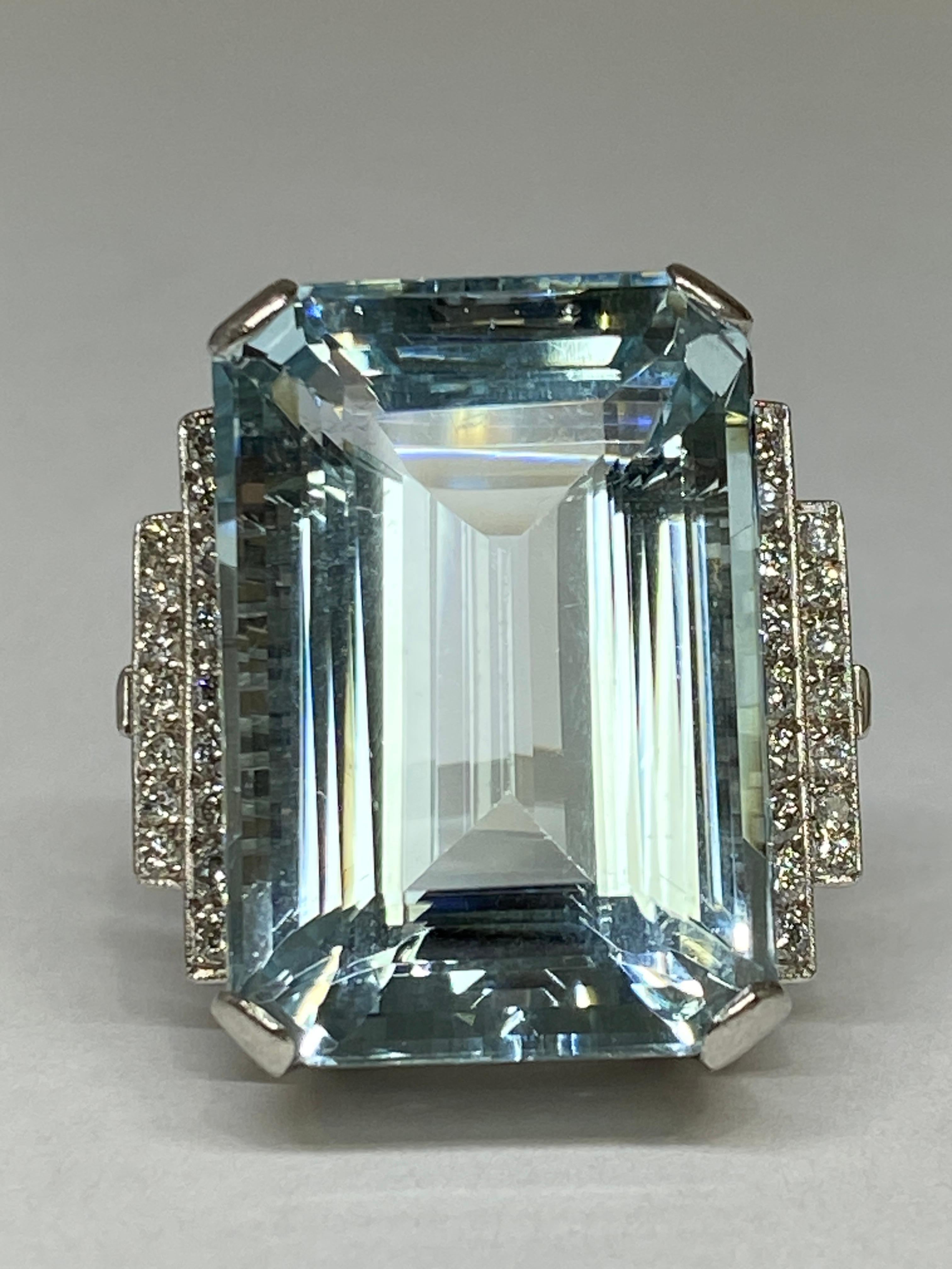 Take a dive into this spectacular crystalline blue aquamarine adorning your finger!  Weighing in at show stopping 38.72carats, the elegantly proportioned emerald-cut aquamarine glistens, gleams, and glows in high profile. Accented at the shoulder