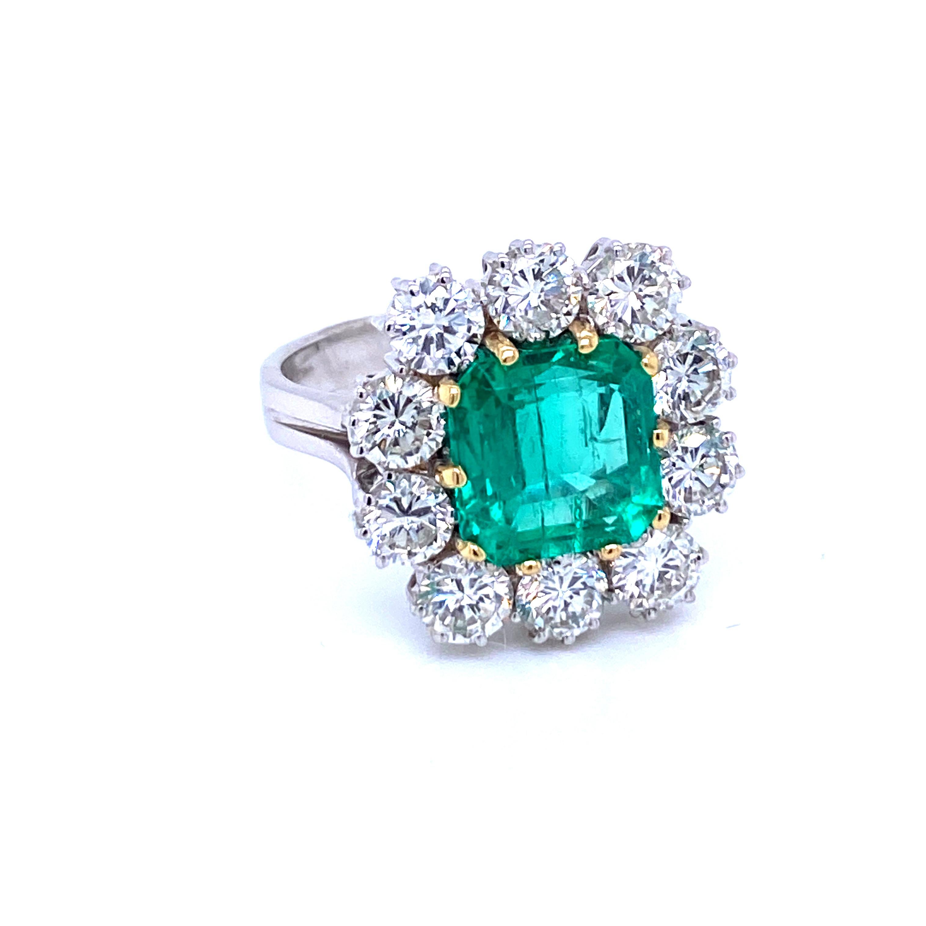 A beautiful and classy 18k white Gold engagement ring showcasing a natural Vivid Colombian Emerald 4 carats of great quality, surrounded by  10 Sparkling Round brilliant cut diamonds, total weight 2.70 carats, graded G color Vvs.
Origin Italy, circa