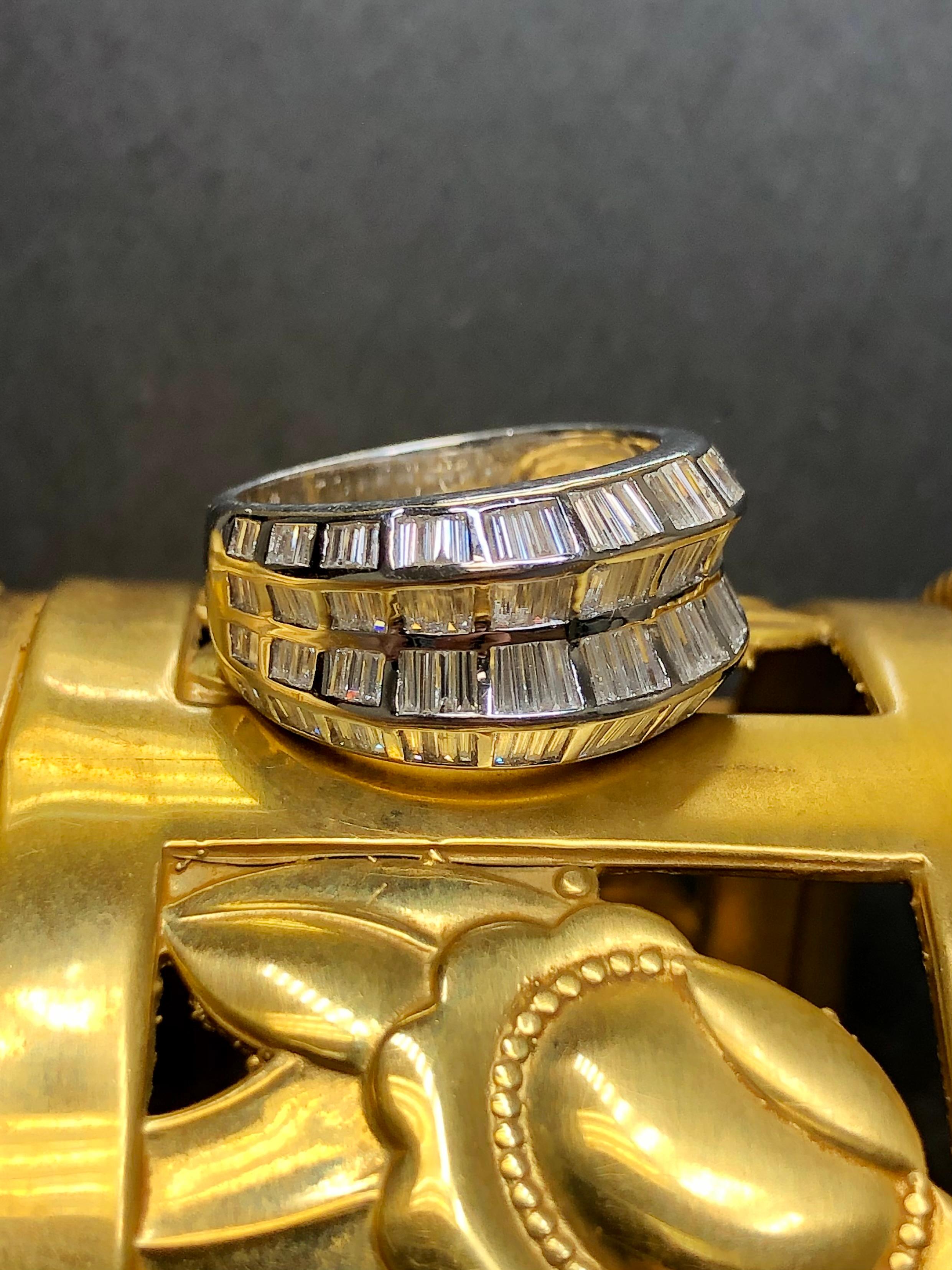 A contemporary ring done in 18K white gold channel set with approximately 4cttw I. G-I color Vs1-Si1 clarity baguette diamonds. Stones do graduate slightly towards the center. A modern but elegant look.


Dimensions/Weight:

Ring measures .45” wide