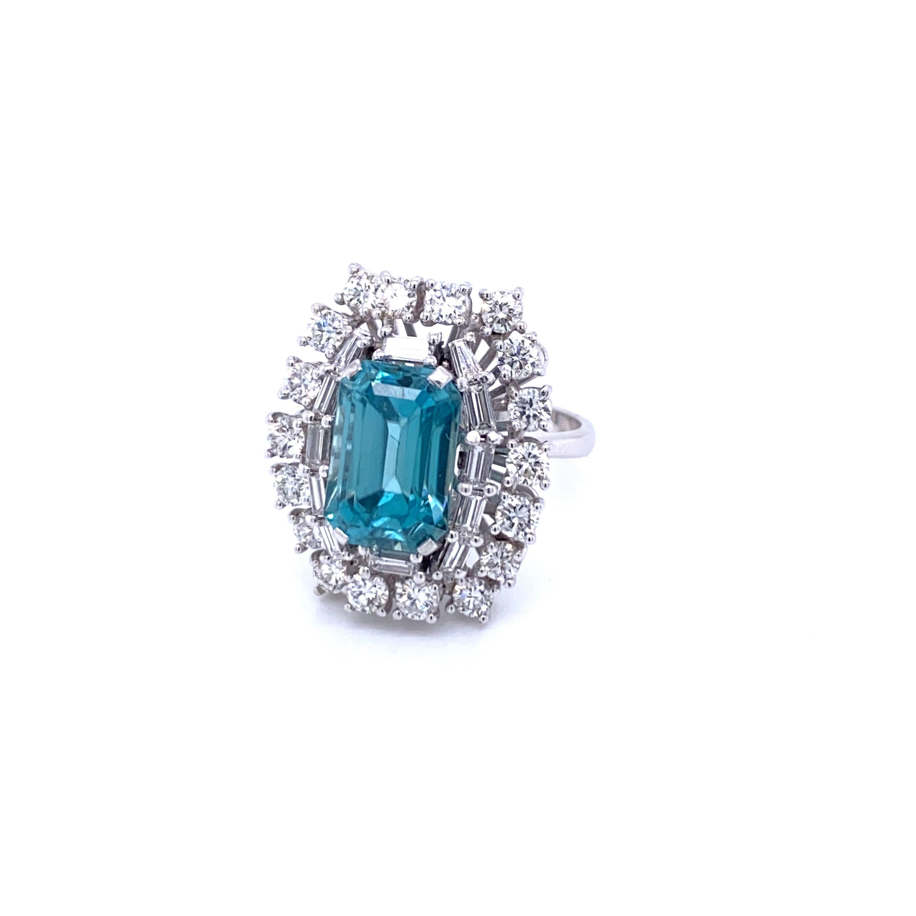 Fine and unusual cocktail ring centering an emerald cut Natural Blu Zircon, weighing approx. 5.00 carat, flanked by 1.80 carats of Sparkling baguette and round brilliant cut Diamonds, graded G color VVS. All set in 18K white gold.

CONDITION: