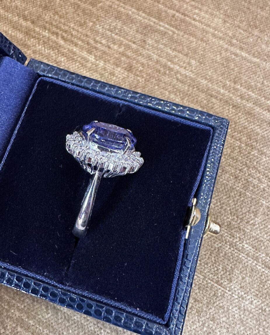 Estate 6.63 carats Oval Tanzanite Ring with Diamond in Platinum

Tanzanite and Diamond Ring features a very clean and lively 6.63 carat Oval Brilliant cut Tanzanite surrounded by a halo of 16 Round Brilliant-cut Diamonds set in a Platinum