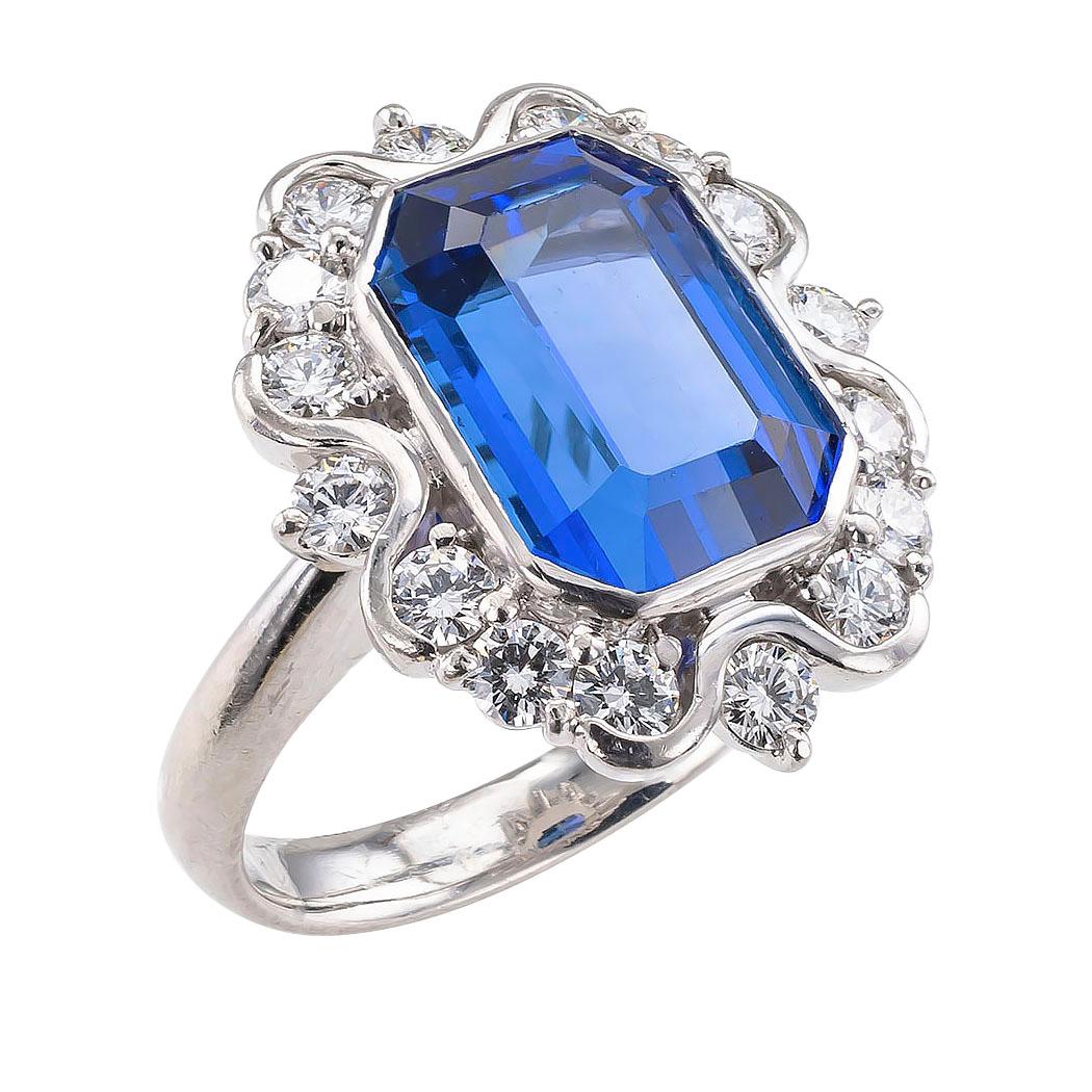 Estate tanzanite diamond and platinum ring.

DETAILS:
GEMSTONES:  one emerald-cut tanzanite weighing approximately 7.69 carats.
DIAMONDS:  sixteen round brilliant-cut diamonds totaling approximately 1.15 carats, approximately H color, VS