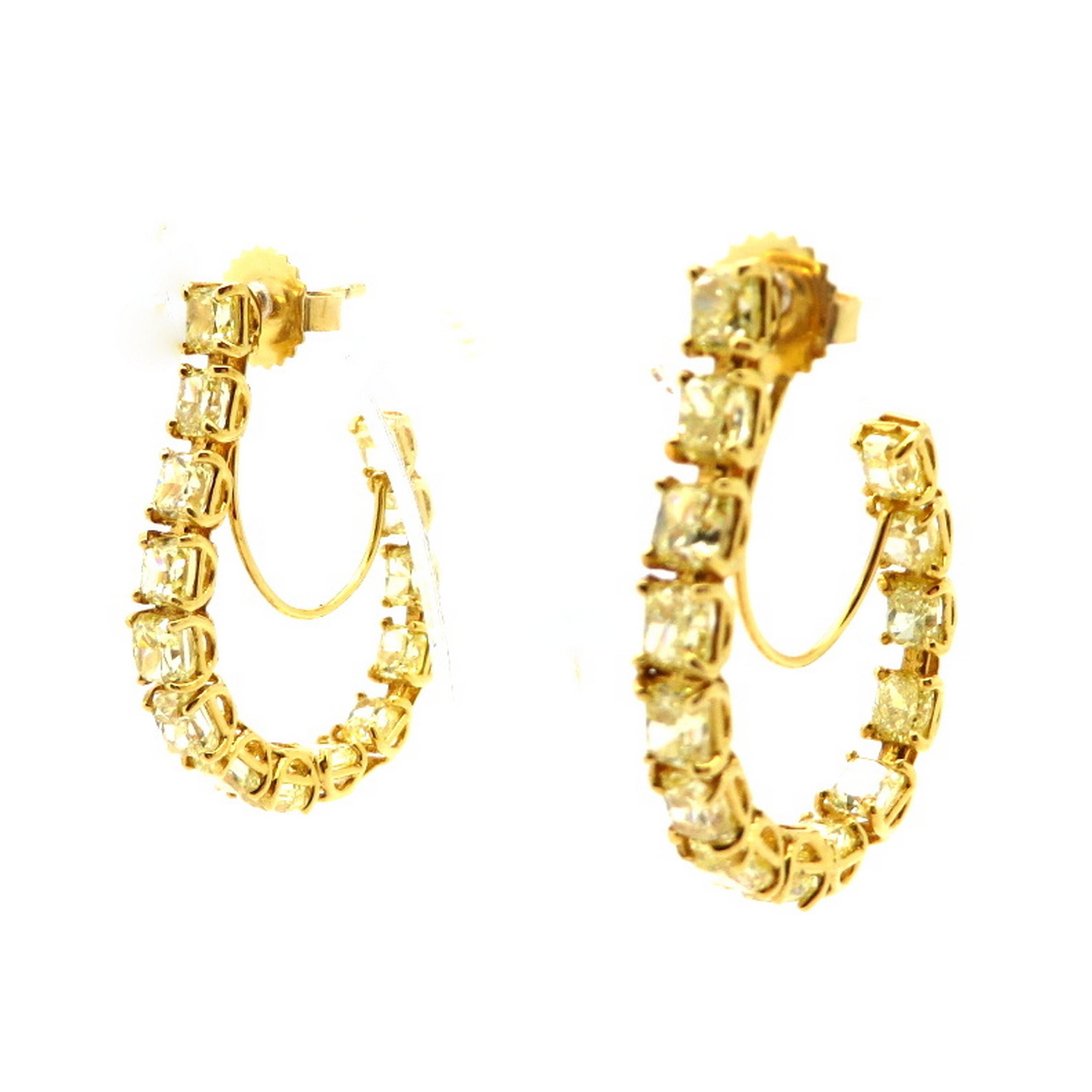 Estate 8.27 carat fancy yellow radiant cut 18K yellow gold diamond hoop earrings. Featuring 28 radiant cut fancy yellow diamonds, each four prong basket set, with various measurements, weighing a combined total of approximately 8.27 carats. Diamond