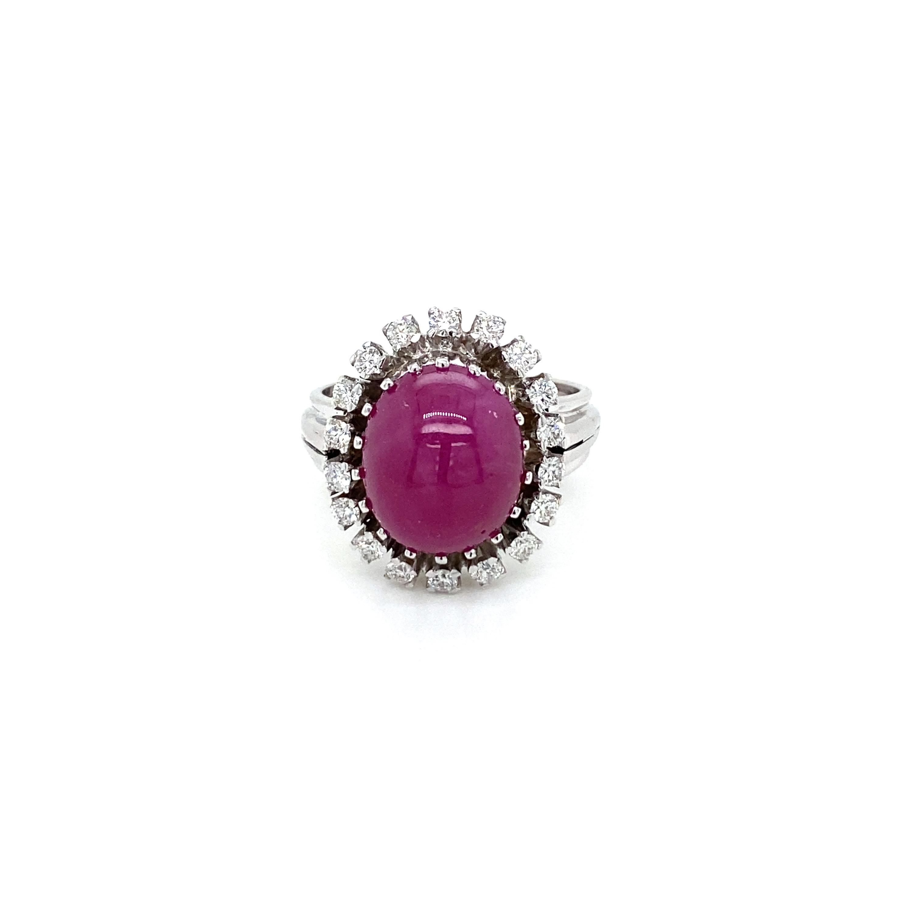 This beautiful cocktail ring is set in the center with one large Natural Cabochon Ruby, perfectly oval shape in intense red color. weight 8.50 ct. surrounded by 0,50 of colorless round brilliant cut diamonds graded G color VVS.

The diamonds are