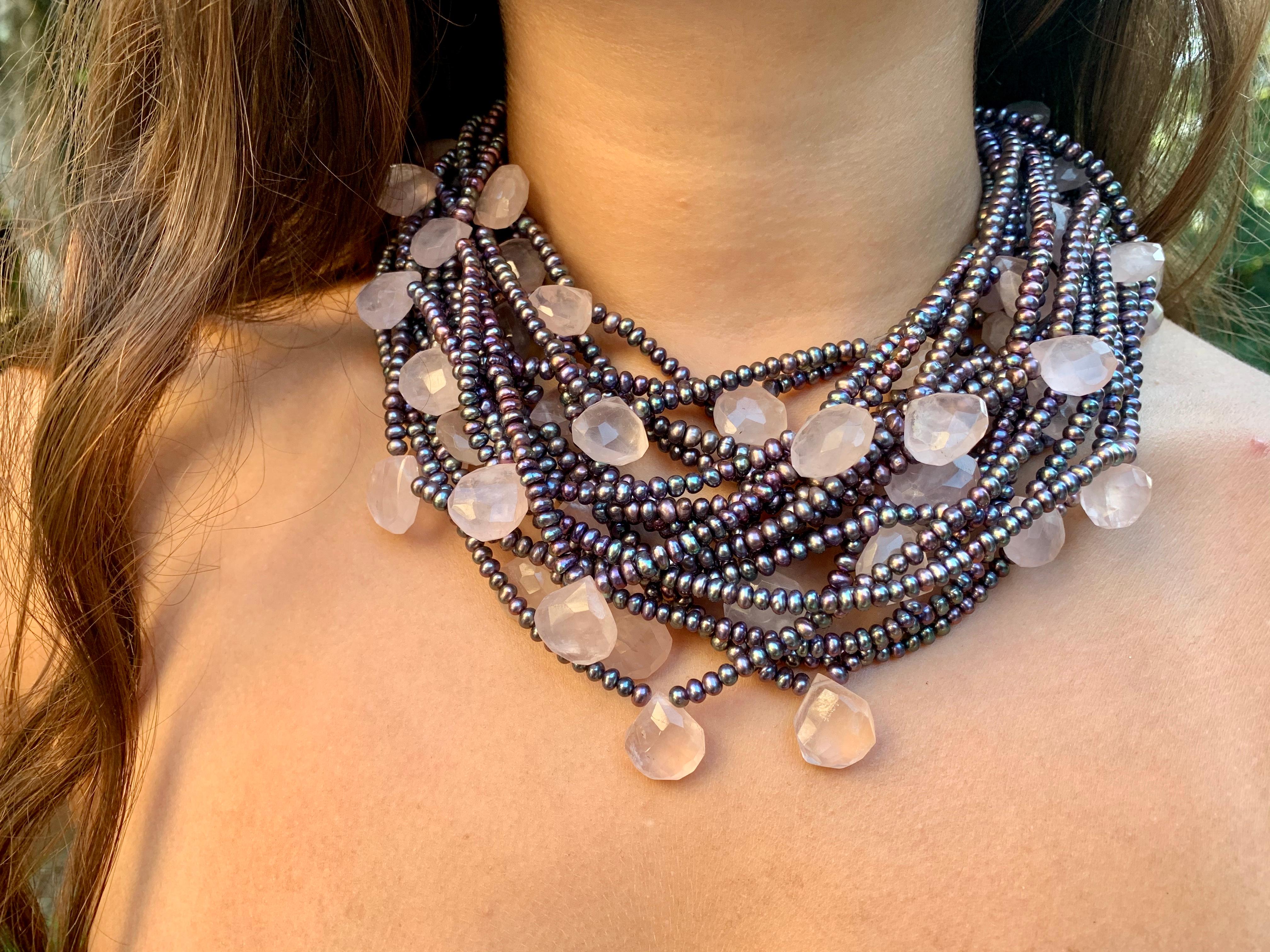 Stunning dramatic statement necklace of black, aubergine, green, blue and silver Akoya pearls and faceted natural pink quartz pendants with a 14K white gold butterfly form clasp. The pearls well matched with good lustre, rich in color, approximately