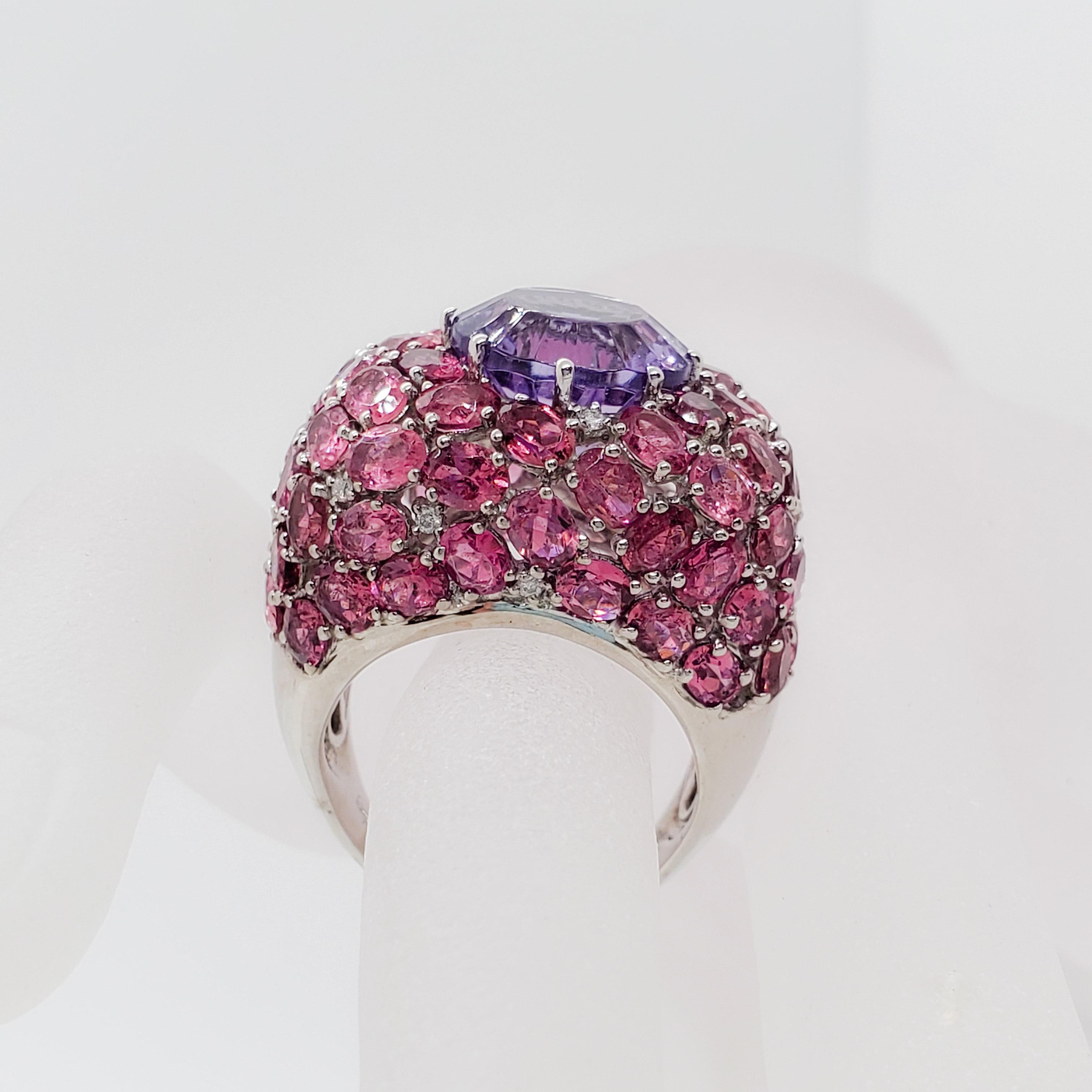 This ring is gorgeous!  Showcasing a 4.05 ct round amethyst, 10.20 cts of pink tourmalines and diamond ovals and rounds in a handmade 18k white gold mounting.  Size 9.  Excellent condition.