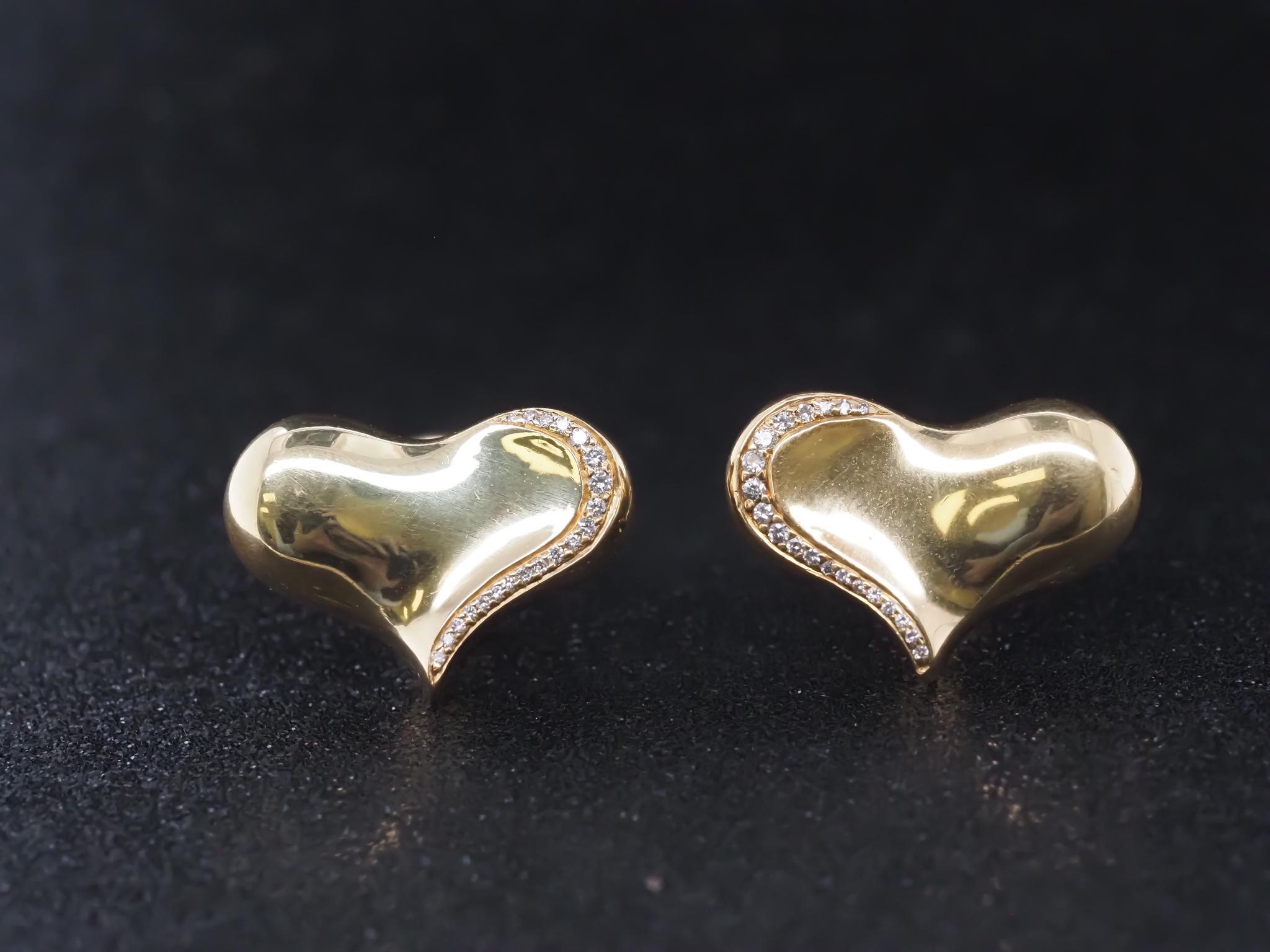 Estate Angela Cummings 18K Gold and Diamond Heart Earrings - VHK#983

Item Details:
Year: 1984 (Signed on the earring)
Metal Type: 18K Yellow Gold [Hallmarked, and Tested]
Weight: 20.1 grams

Diamond Details:
.40ct total weight, Round Brilliant, F