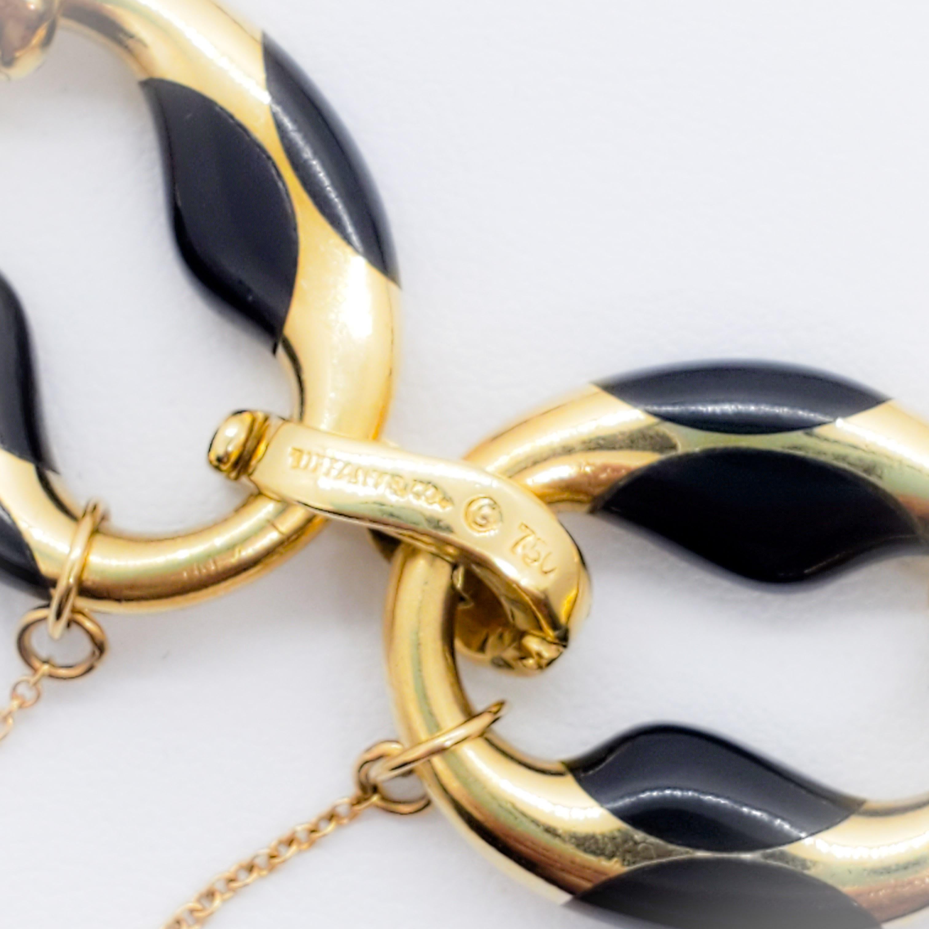 Hard to find black enamel and yellow gold bracelet by legendary designer Angela Cummings for Tiffany & Company.  This bracelet is a collector's dream come true.  From the prestigious line of Angela Cummings, that bracelet is the epitome of her