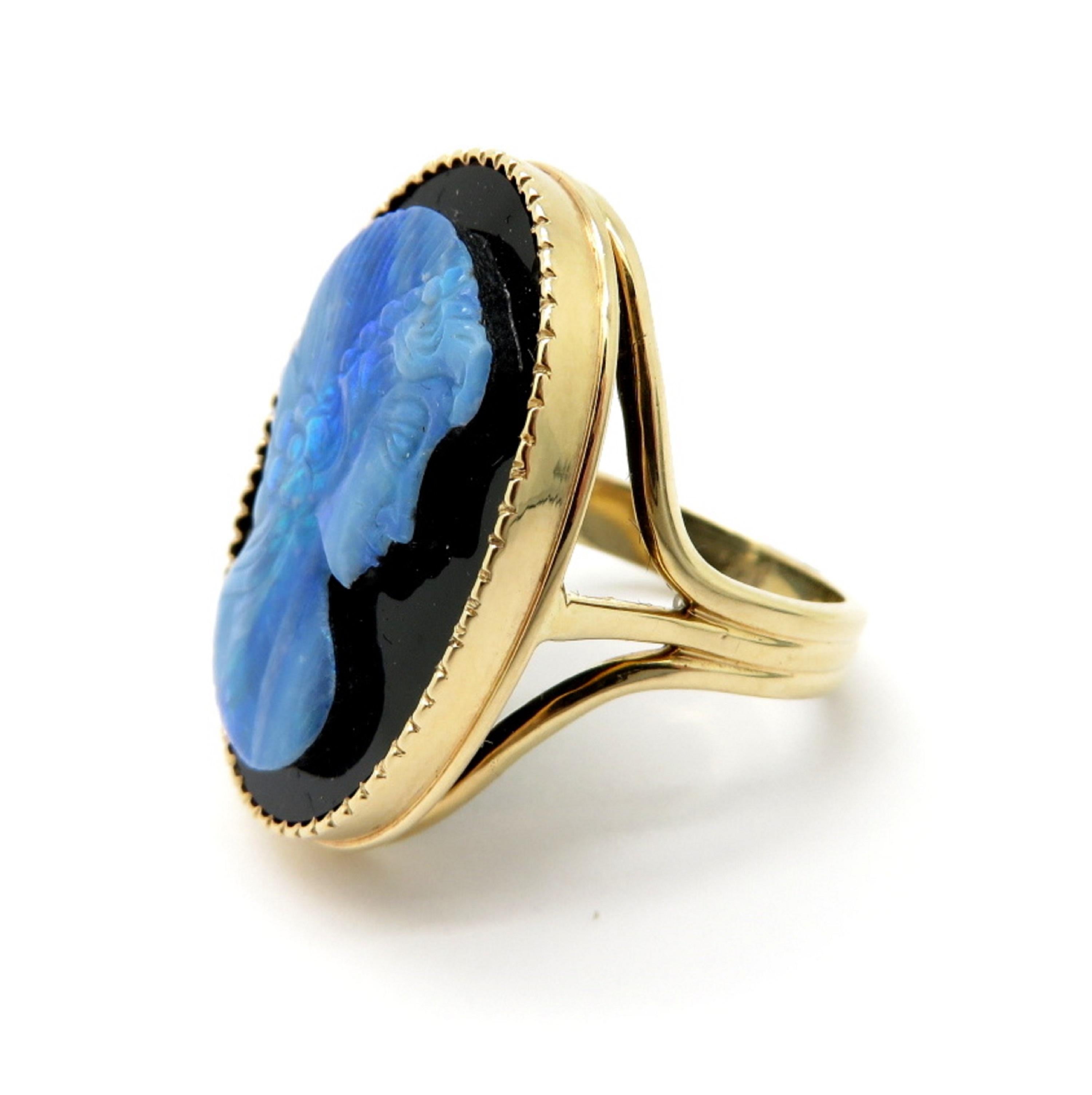 Estate 14K yellow gold onyx and oval cameo ring. Showcasing one fine quality black opal carved in the shape of a woman’s portrait. Displaying one oval black onyx gemstone framed in yellow gold. The ring has a high polish finish. It is a finger size