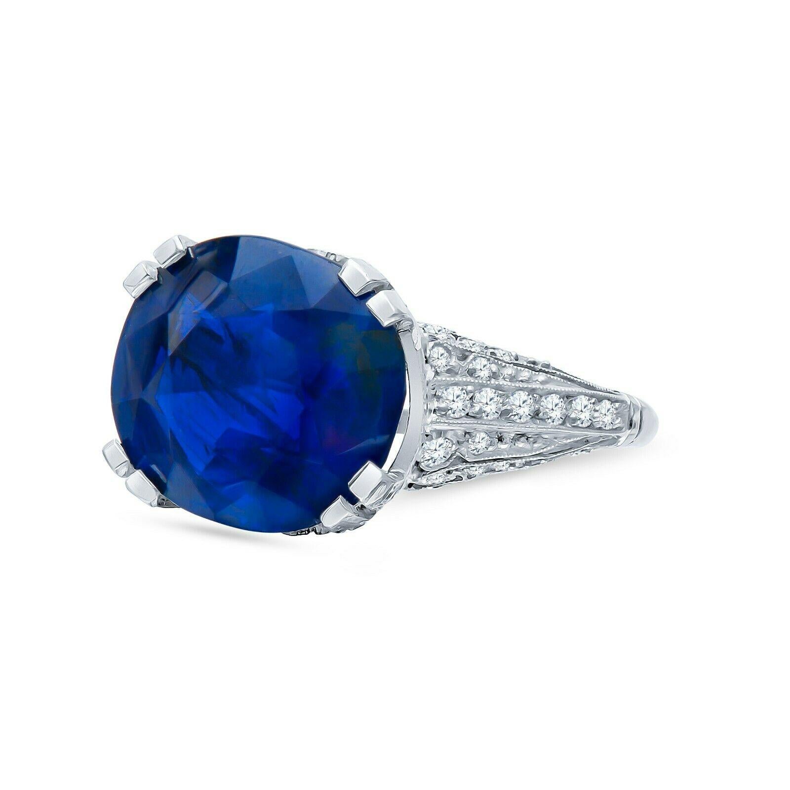 This is an absolutely gorgeous Estate Antique Art Deco Platinum 11.91 CTW Cushion Cut Sapphire Diamond Engagement Ring. The center stone is a Burma Sapphire with no heat and royal blue color which is extremely rare. It weighs 10.41 carats and is