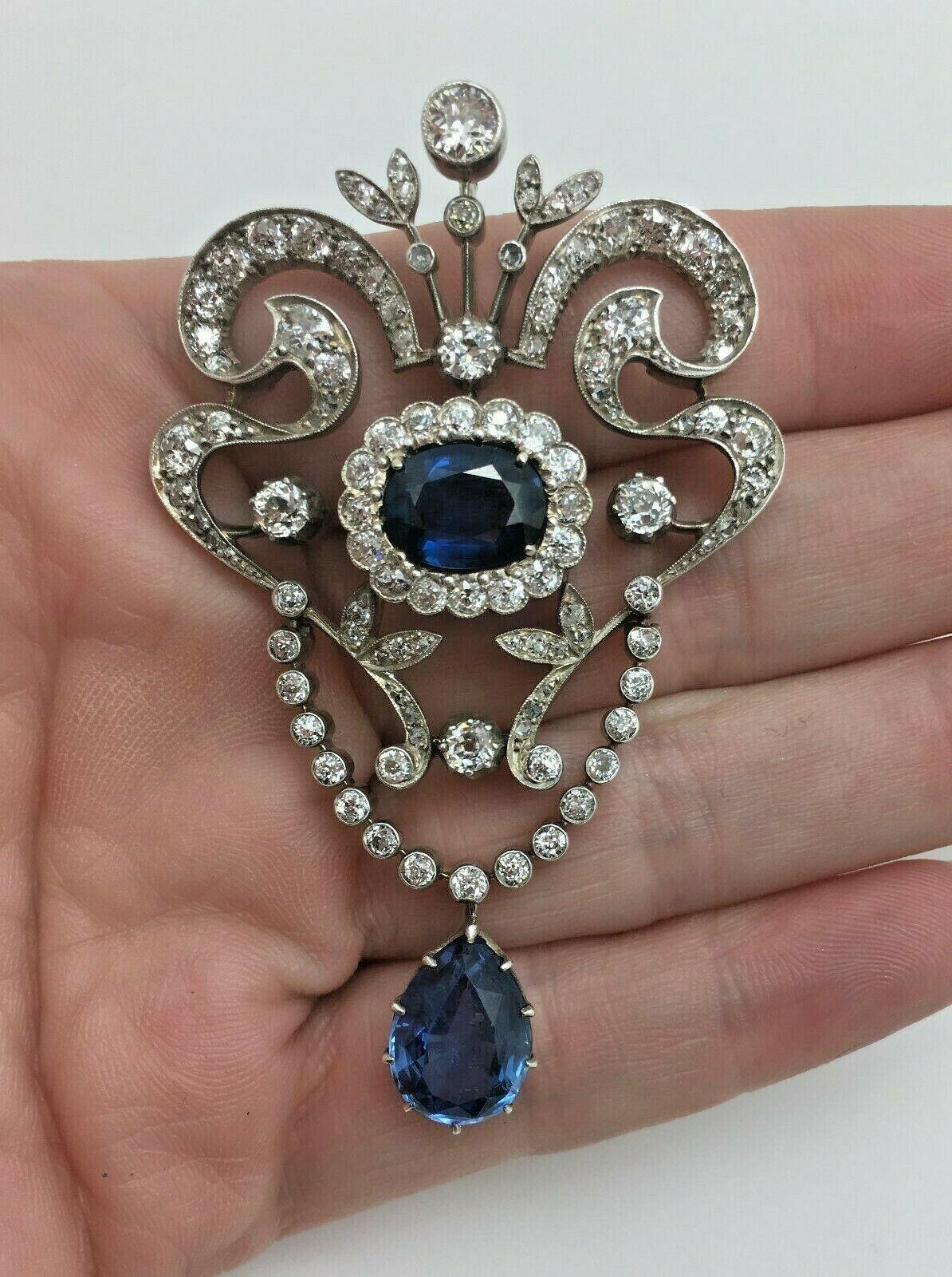 Estate Art Deco Platinum 12.86 Old European Cut Diamonds & Sapphire Brooch Pin

One Oval Shaped Natural Blue Sapphire, Measuring 10.28 x 7.86x 4.33mm, Weighing Approximately 4.00 Carat Total Weight.
Origin: Thailand

One Pear Shaped Natural Blue