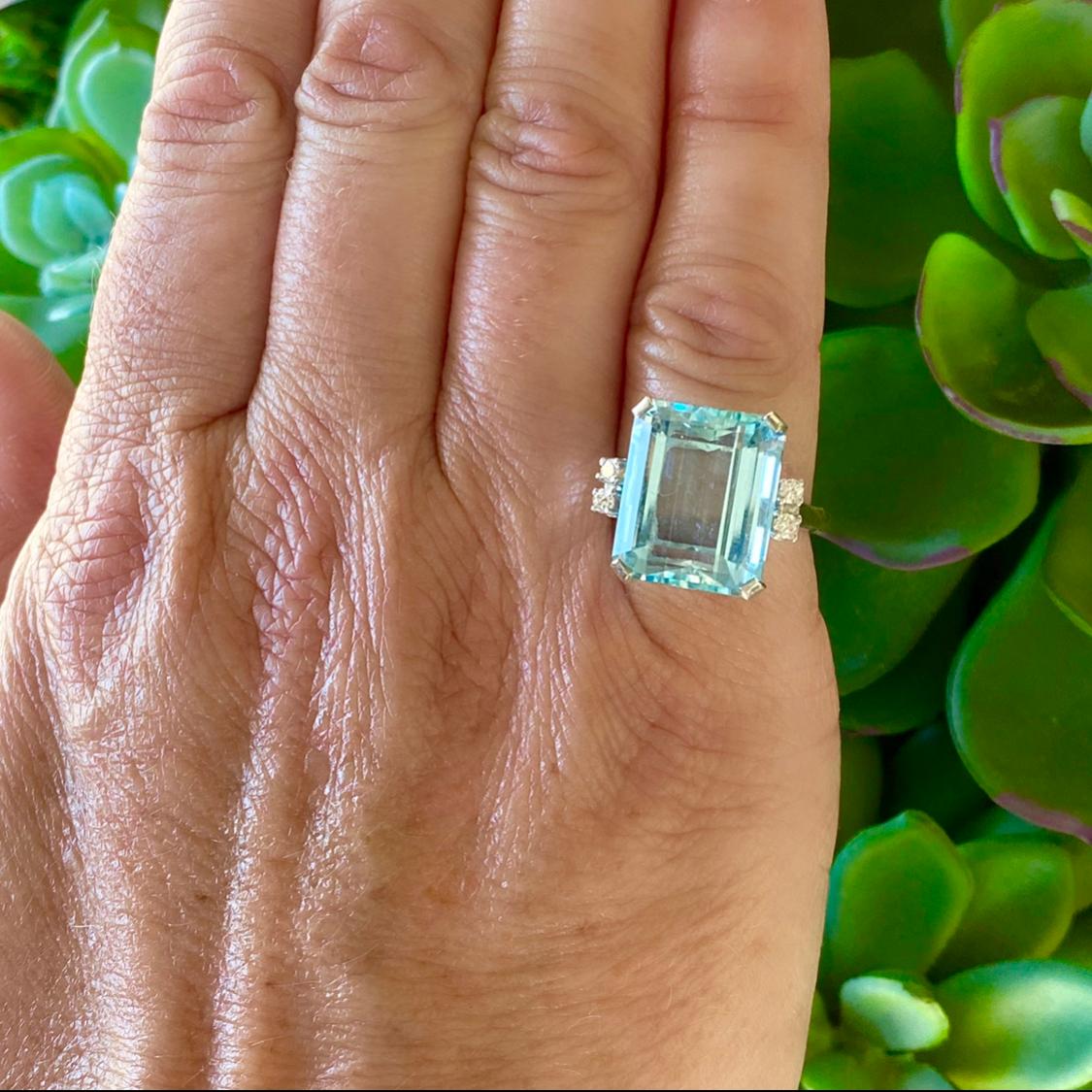 Enjoy the uplifting color of this sky blue aquamarine ring! The 14k white gold highlights this rectangular-cur aqua, weighing approximately 9.50 carats, accented by four round brilliant-cut diamonds totaling 0.12-ct. The ring wighs 7.0 grams, and is
