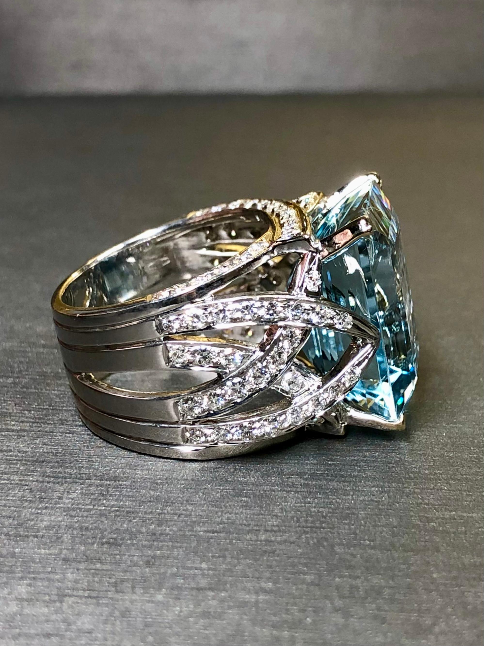An impressive cocktail ring done in 18K white gold by Italian maker, AREZZO. It is centered by a 15.93ct natural emerald cut aquamarine and flanked by 1.20cttw in F-G color Vs1-2 clarity round diamonds set throughout. A large cocktail with quite the