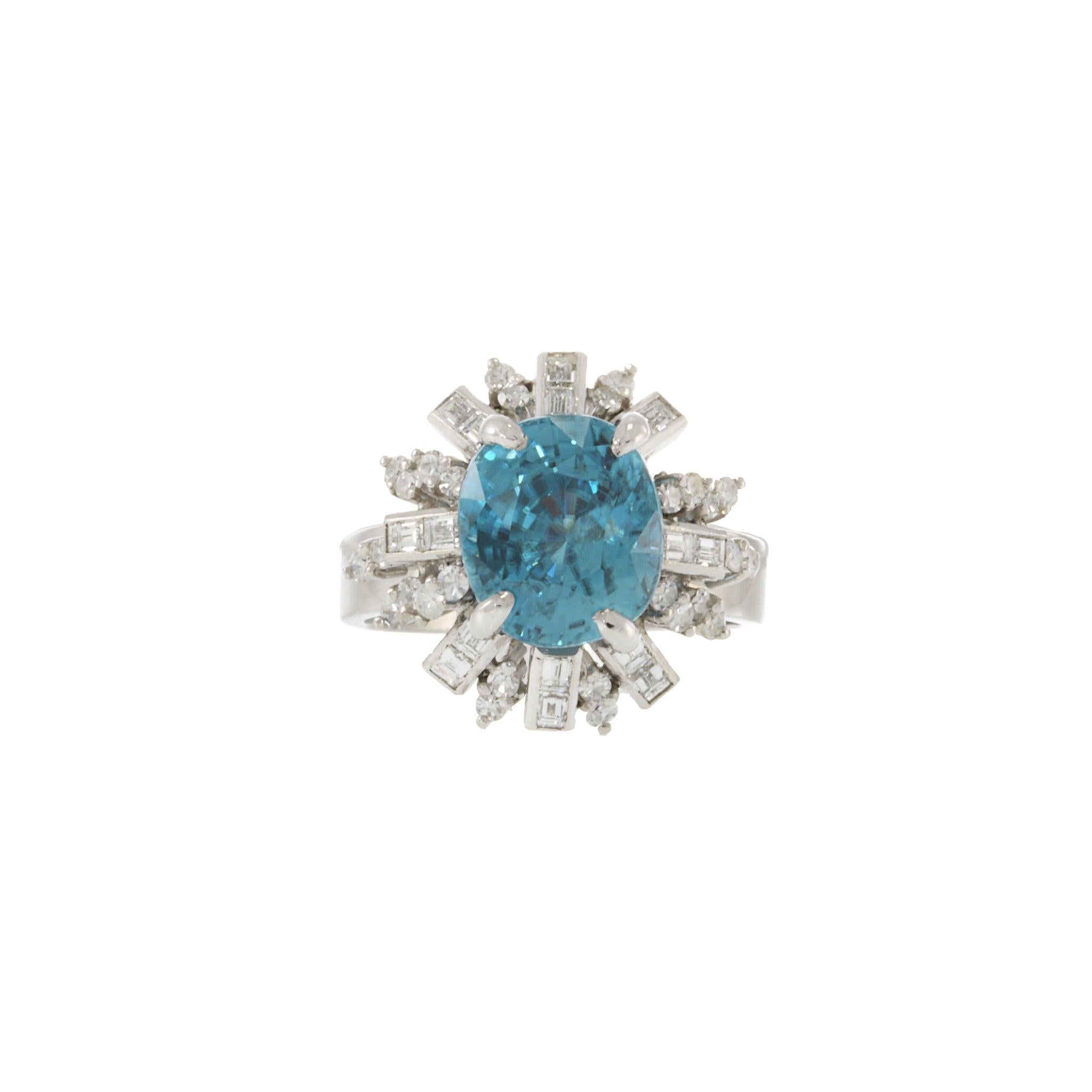 This Art Deco period ring features a stunning 7.50 carat blue zircon gemstone at the center, surrounded by a halo of 2.00 carats total weight of F-G VS single cut round and emerald cut diamonds. The ring is set in 14kt white gold, a popular choice
