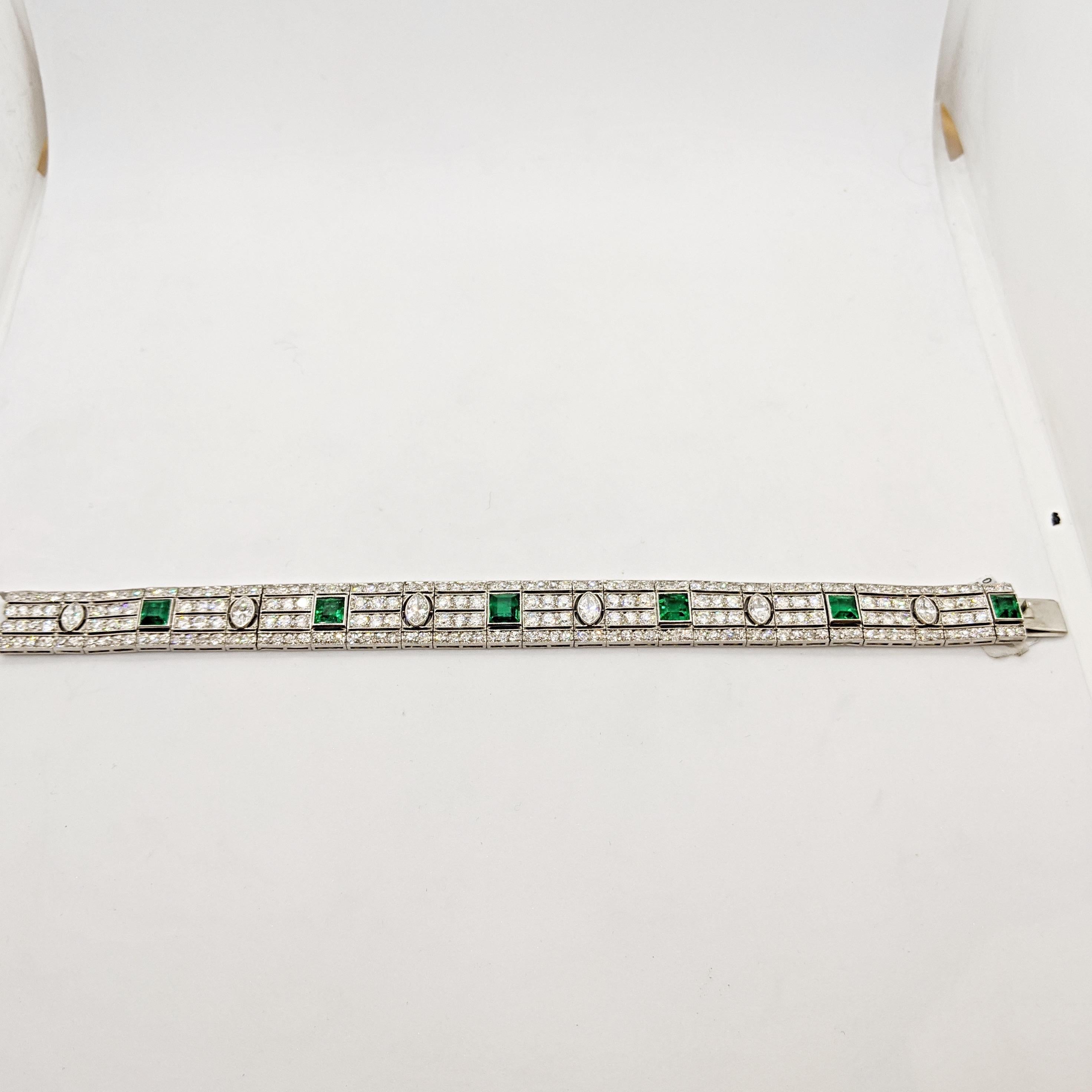 This Estate bracelet features six Emerald-cut Columbian Emeralds and six Marquis cut Diamonds. The magnificent stones are set in a platinum bracelet with four rows of Round Brilliant cut Diamonds. The setting design is a unique piece coming from the
