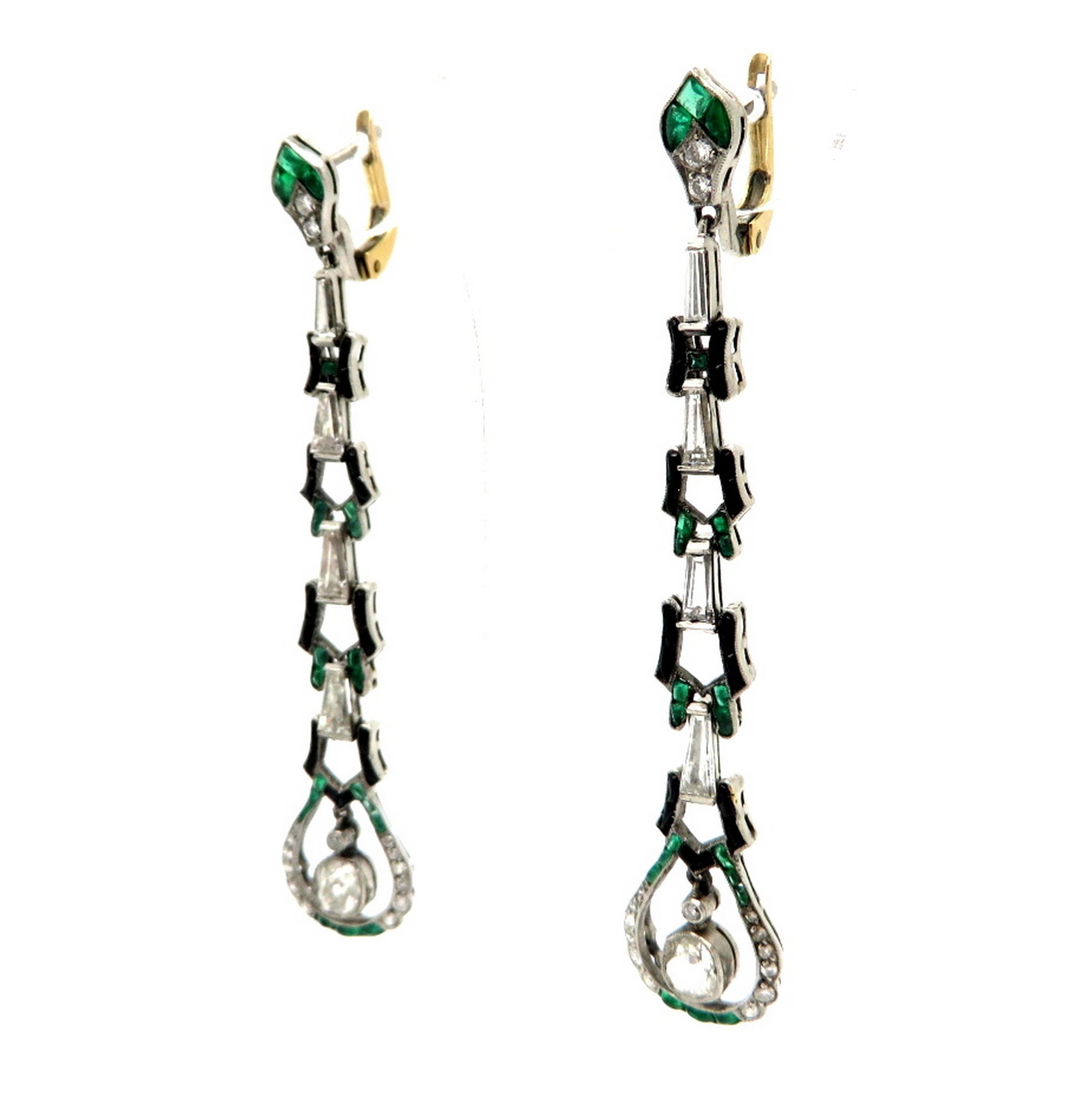 Estate Art Deco style platinum and 18K gold diamond, emerald and onyx dangle earrings. Showcasing two Old mine cut diamonds, weighing a total of 0.75 carats. Accented with 6 tapered baguette shaped diamonds weighing a combined total of 1.15 carats