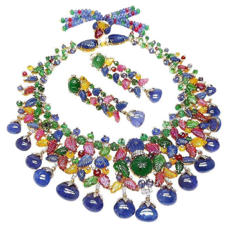 Estate Art Deco tutti Frutti Inspired Carved Gemstone and Diamond Necklace, This 579 carat necklace set is hand set in 136 gm 14k solid yellow Gold with 11.15 carats of diamond, 120 carats of Emerald, 80 carats of Blue Sapphire, 17 carats of