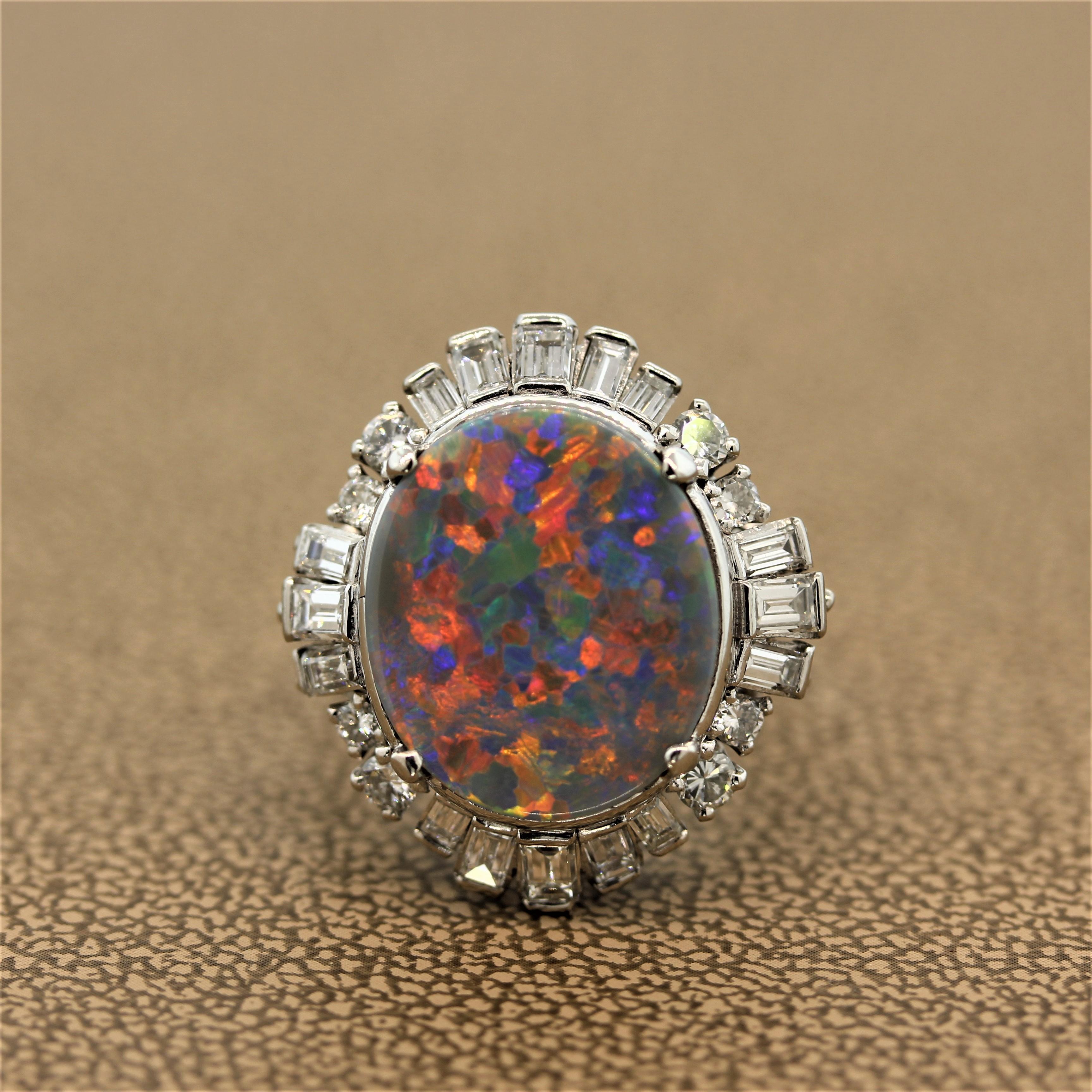 An estate ring with a powerfully unique 5.15 carat Australian opal with exceptional play of color. The play of color in this semi-black opal is remarkably eye-catching with flashes of intense red, blue and green. The halo of 1.48 carats of colorless