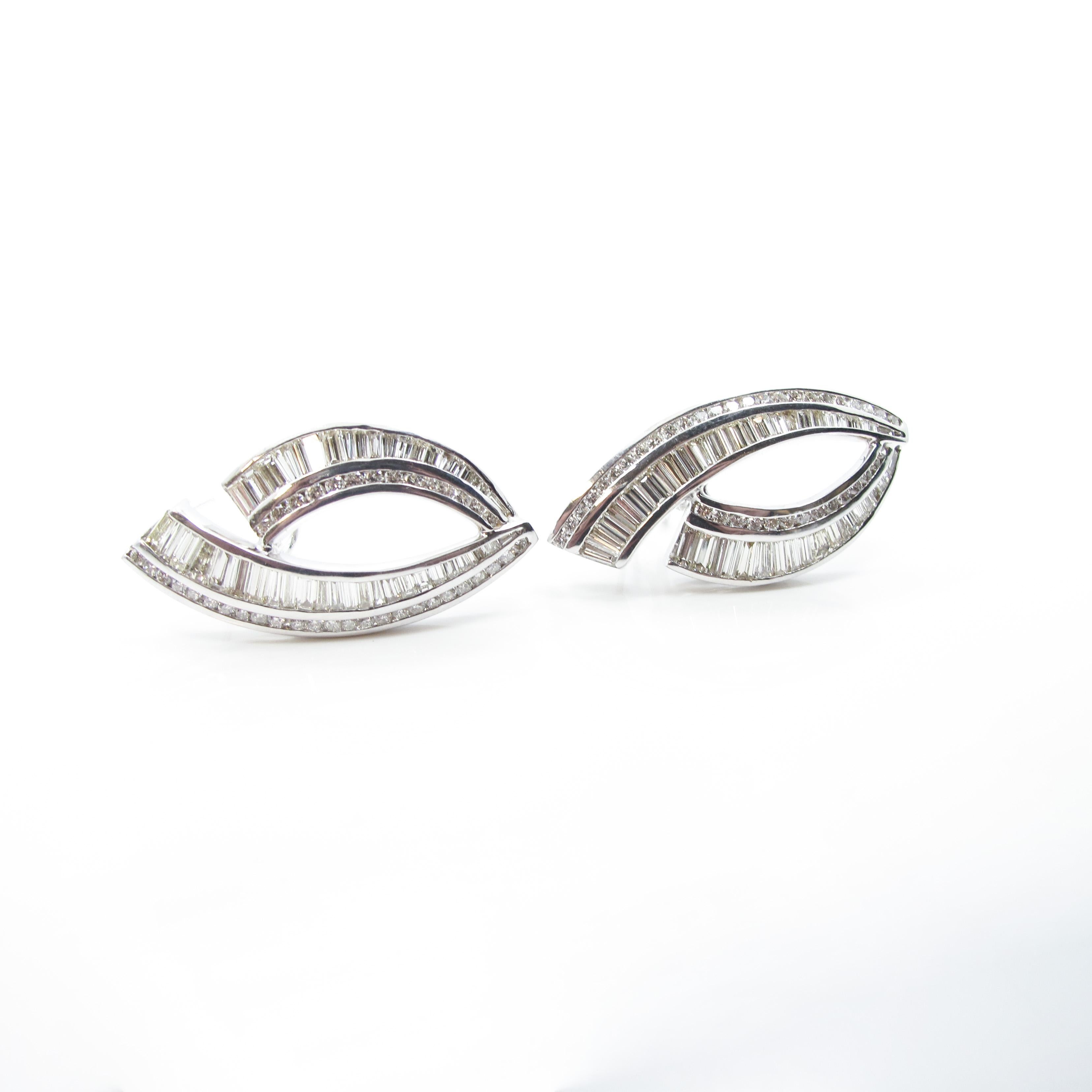 Estate baguette and round brilliant diamond earrings set in 18k white gold. The earrings feature 88 straight and tapered baguette diamonds weighing approximately 6.40ct total weight and 78 round brilliant diamonds weighing 1.56ct total weight, all