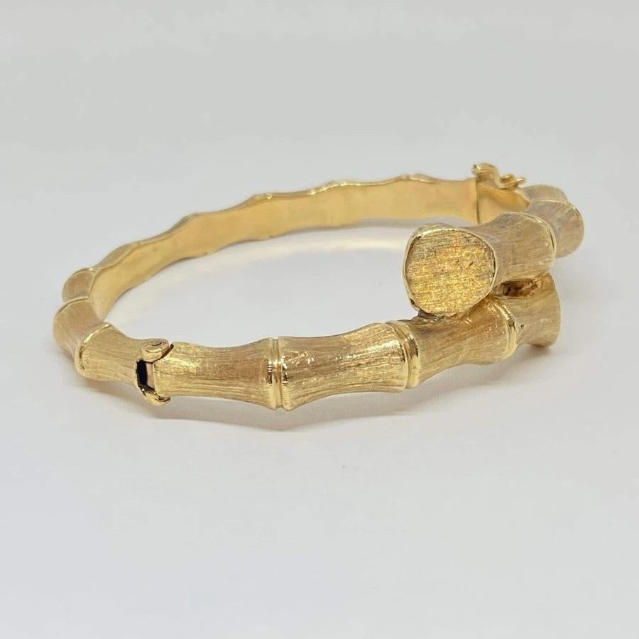 Estate bamboo bangle bracelet designed in 14K yellow gold, measures 15mm wide tapering to 4mm. Fits 6-8
