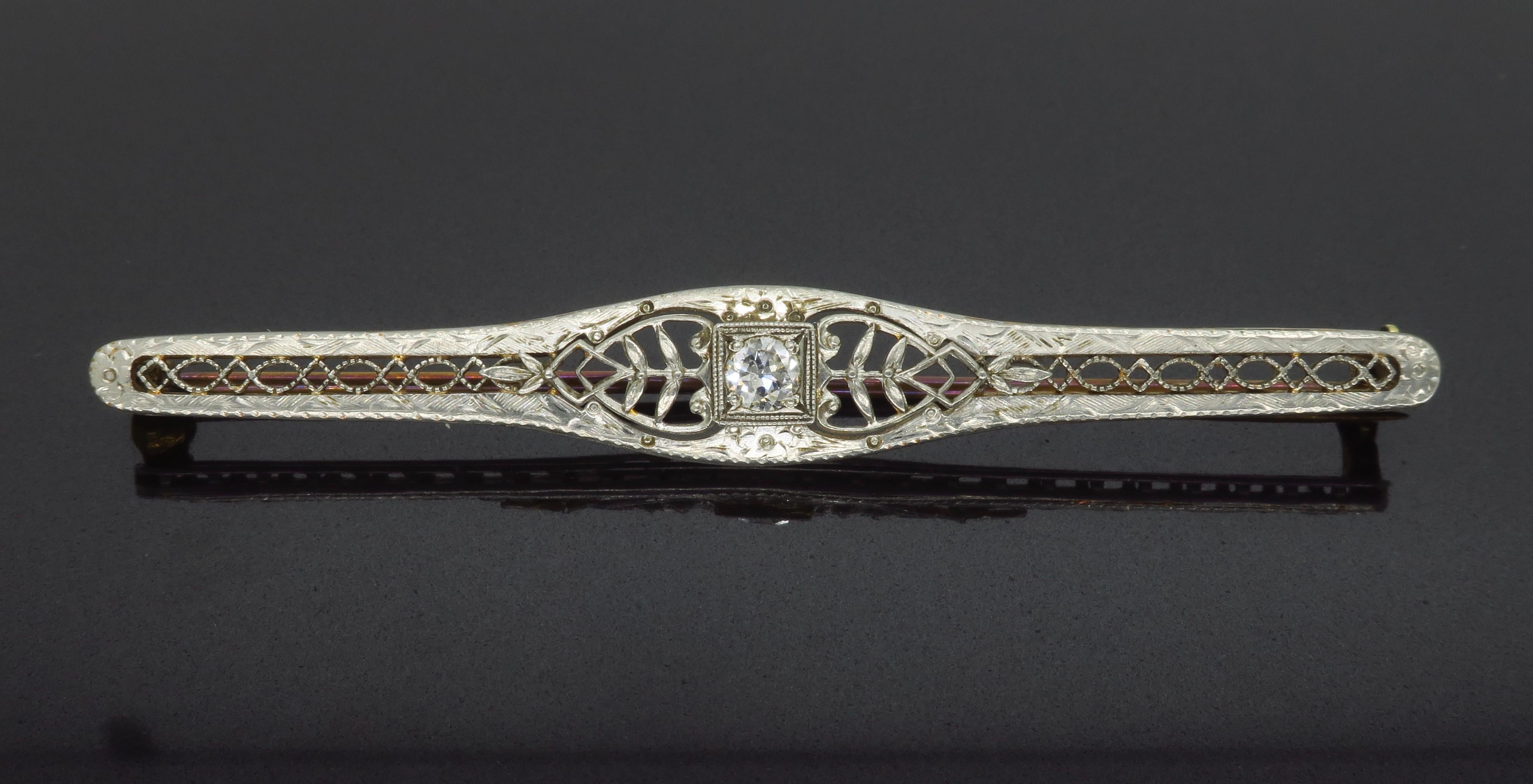 Estate bar style brooch made in Platinum and Gold. 

Diamond Carat Weight: Approximately .15CT
Diamond Cut: Old European Cut 
Color: F-G
Clarity: SI1
Metal: Platinum & 14k Gold 
Weight: 3.6 Grams
Length: Approximately 2.5” Long