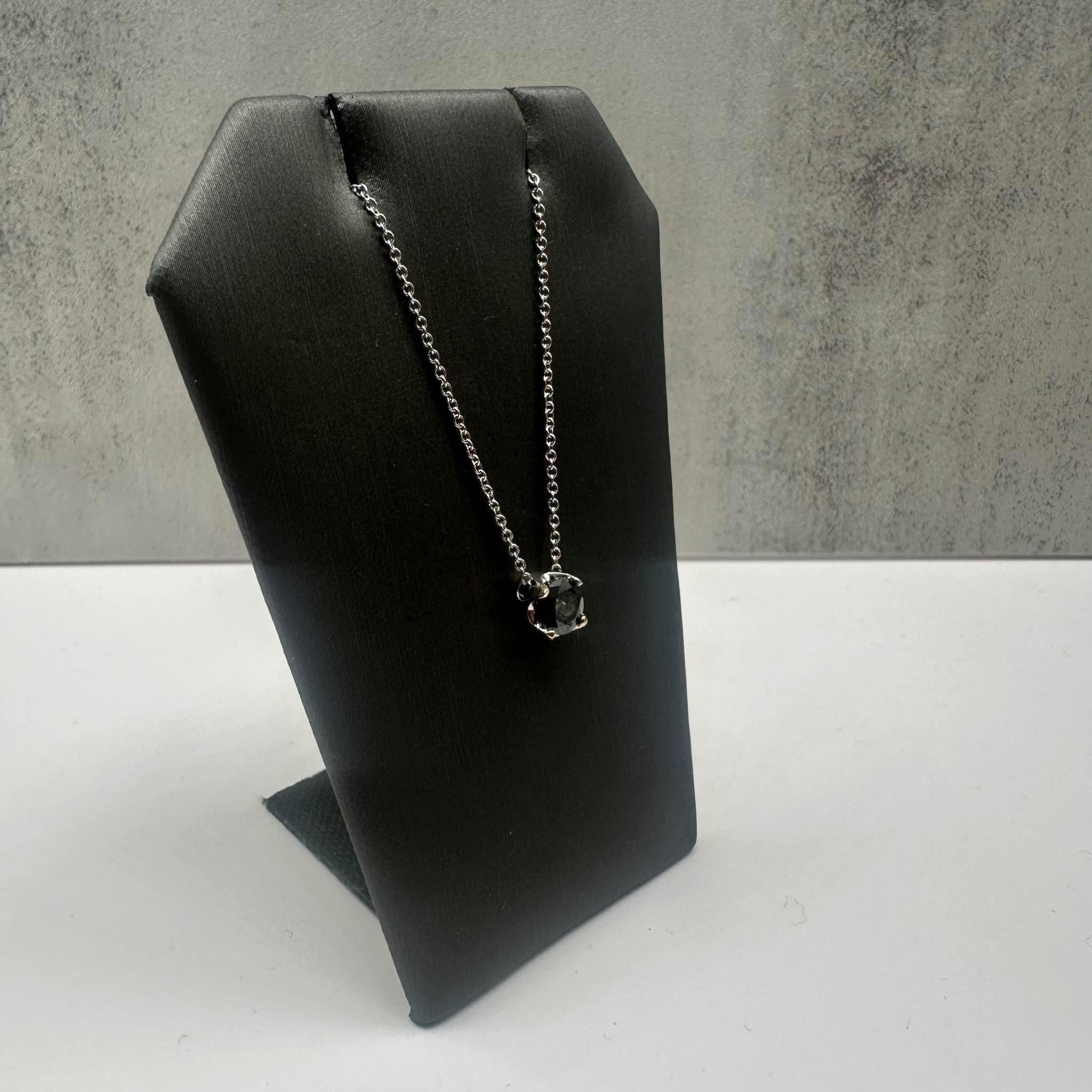This stunning Estate Black Diamond Necklace in 18kt white gold features approximately 0.75ctw of round black diamonds, offering a bold and sophisticated look. With an 18-inch length, it sits elegantly around the neckline and is perfect for both
