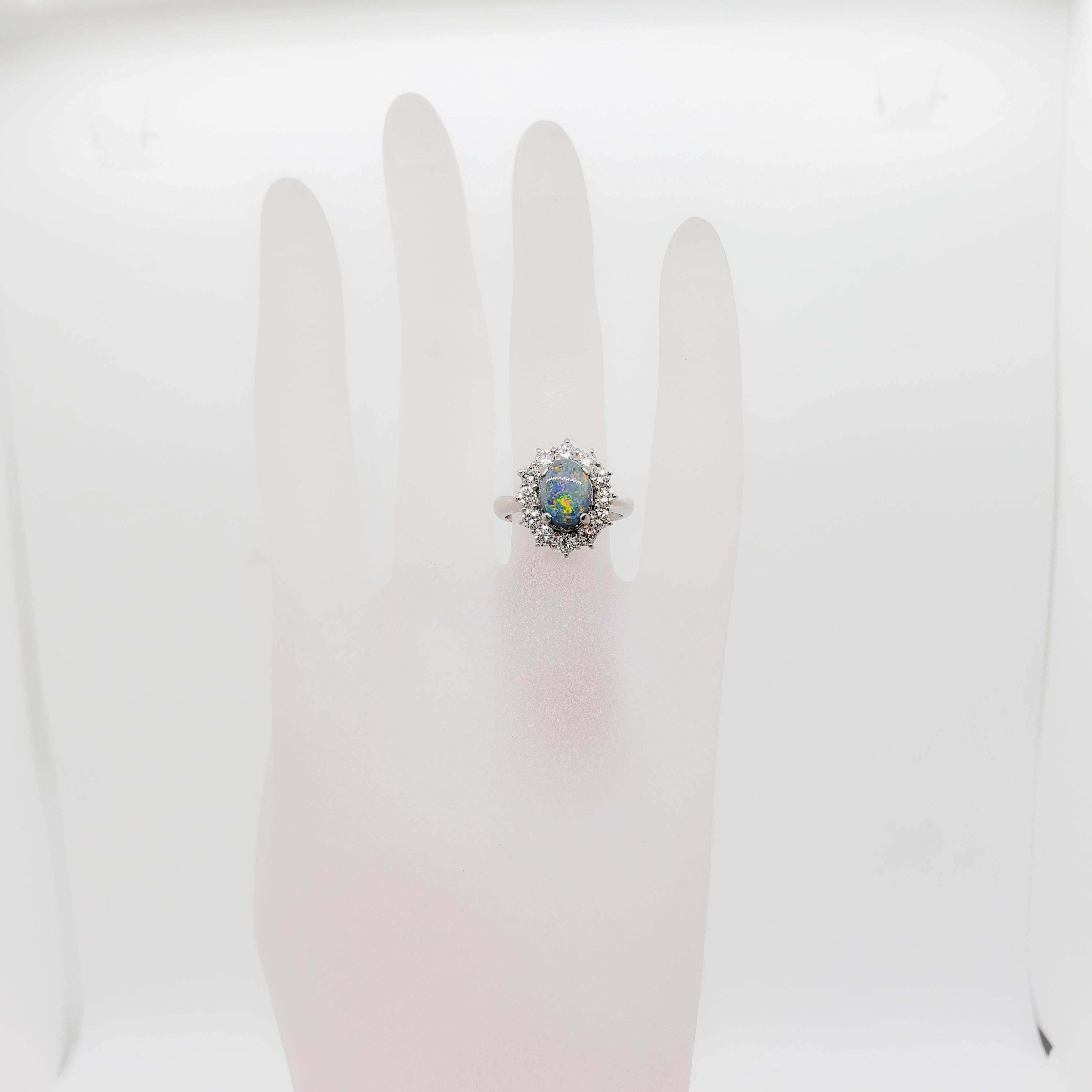 Stunning 1.86 ct black opal oval cabochon with a greyish blue color and sparks of orange, yellow, and green.  1.00 ct. of good quality, white, and bright diamond rounds.  Handmade mounting in platinum.  Ring size 6.5.  Mint condition.