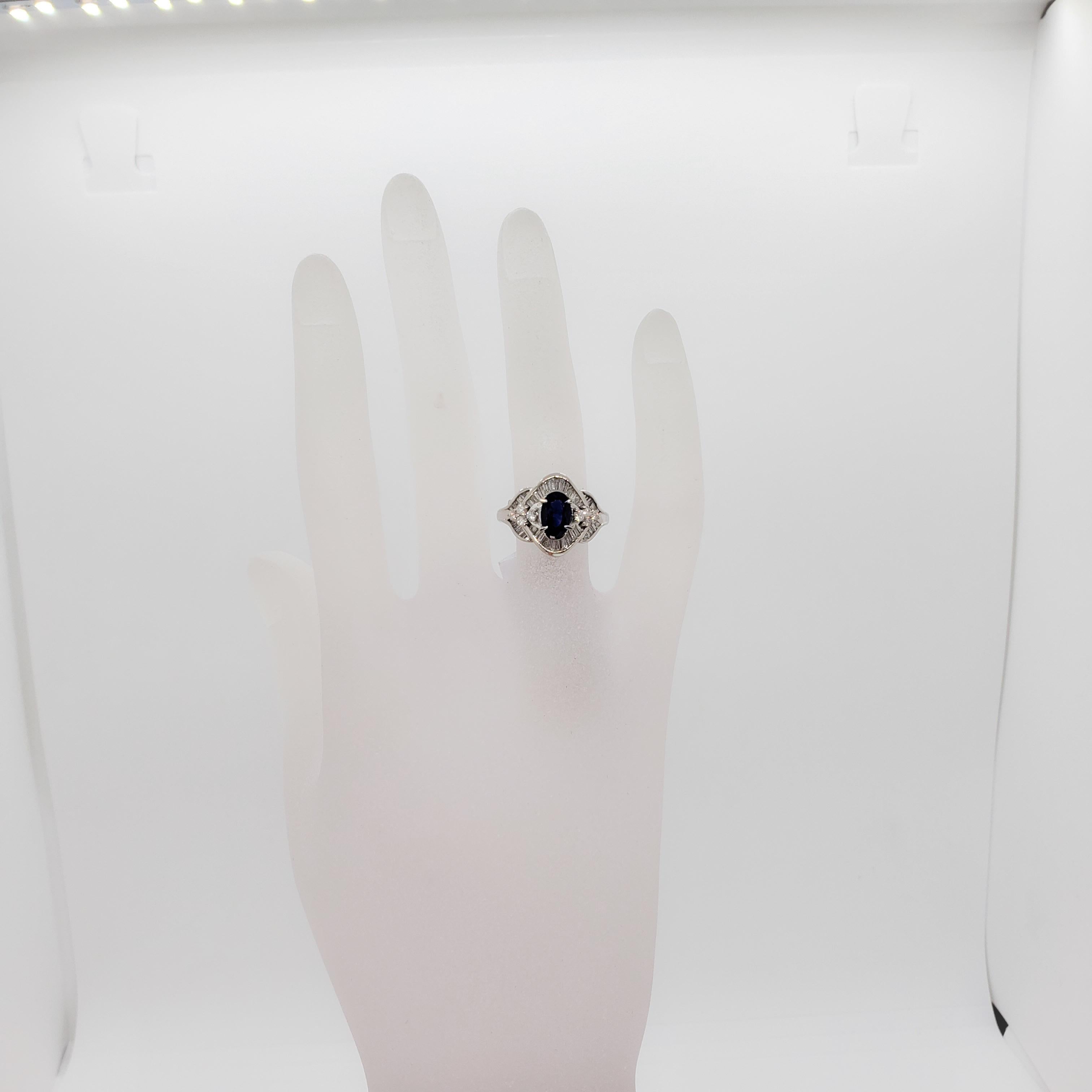 Beautiful deep color blue sapphire oval weighing 1.23 ct. with 0.80 ct. of good quality white diamond rounds and baguettes.  Handmade platinum mounting in size 6.25.  Mint Condition.