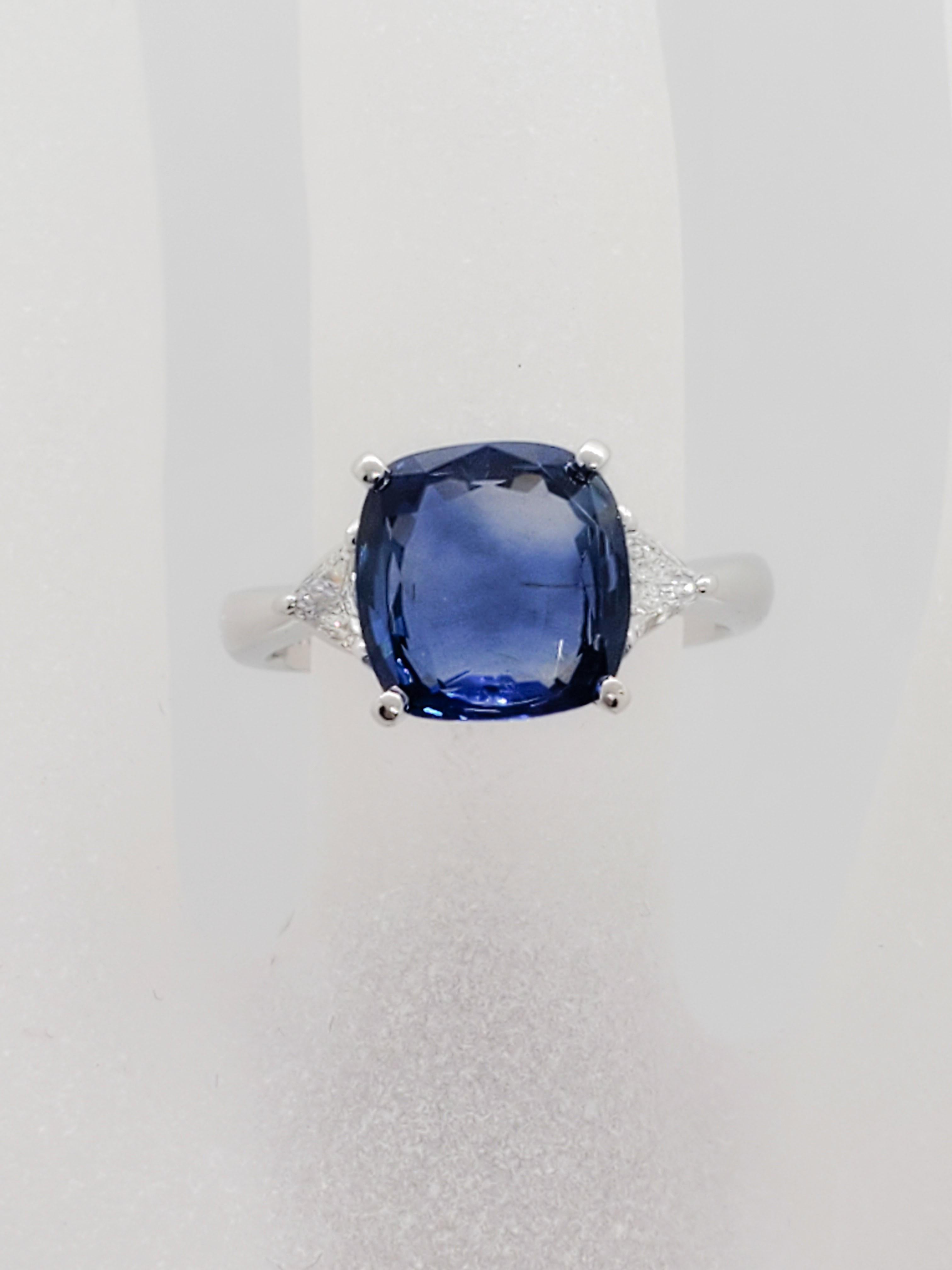 Gorgeous 4.44 ct blue sapphire square cushion that has a bright blue color and perfect shape. The diamond trillions weigh 0.26 ct and are good quality, white, and bright. Ring size is 5.5. Handmade mounting in platinum.