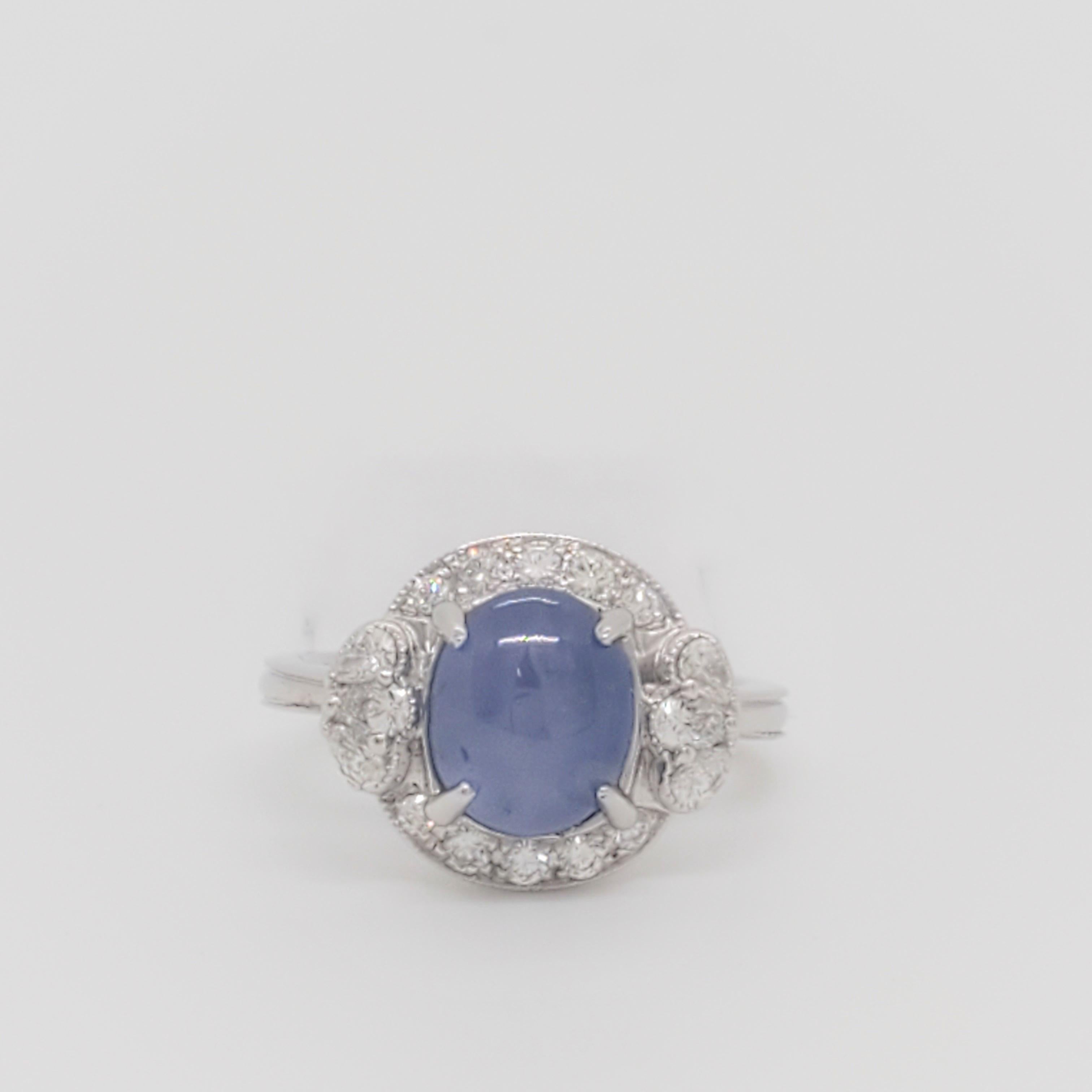 Gorgeous 4.93 ct. blue star sapphire oval cabochon with 0.49 ct. good quality white diamond pear shapes and rounds.  Handmade 18k white gold mounting. Ring size 6.25.