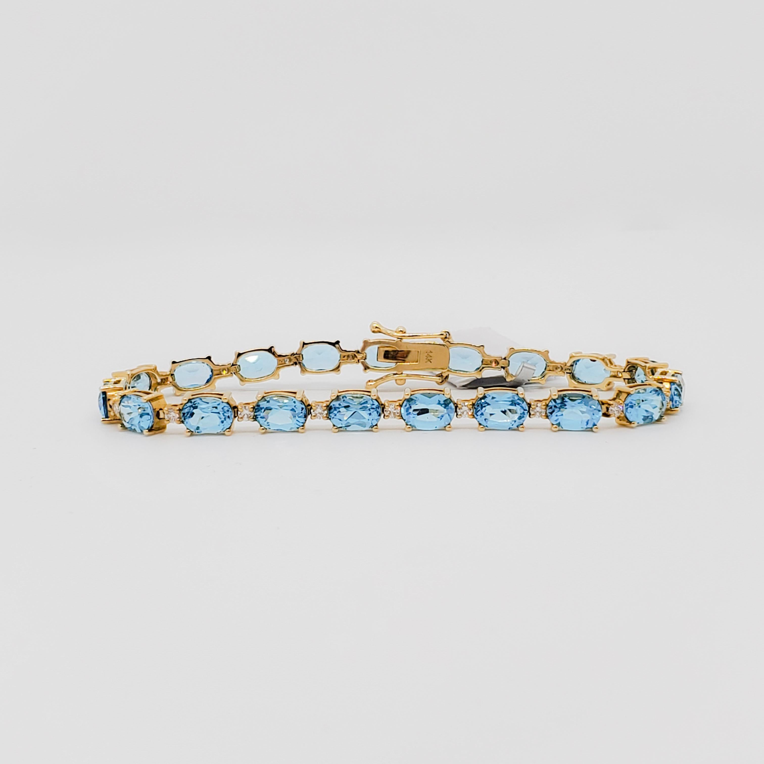 Oval Cut Blue Topaz and Diamond Straight Line Bracelet in 14k Yellow Gold For Sale