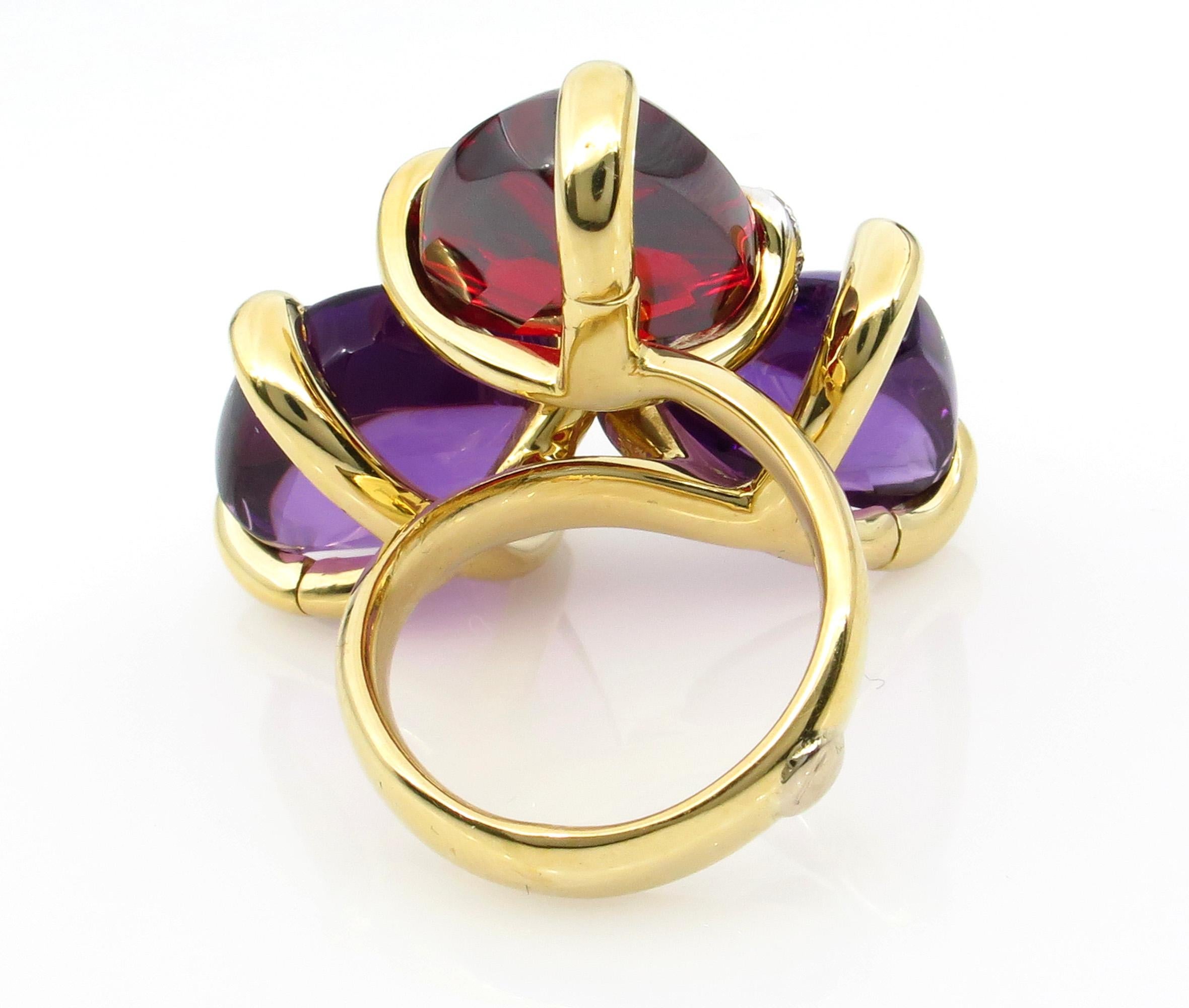 Bold and Fashionable Garnet, Amethyst and Diamonds in bright 18k Yellow Gold. 
A real Statement jewel, a gear Right Hand or Anniversary Ring! From our Estate Collection. The ring is in 18K Yellow Gold. The Three gem stones is accented with small